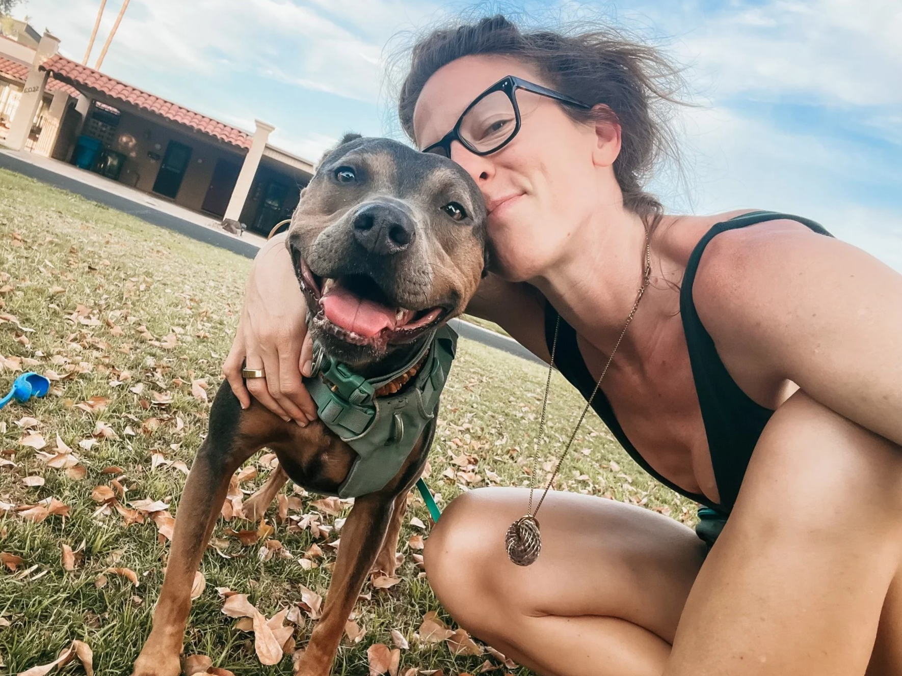 Dr. Elizabeth Anderson with her dog Luna, outdoors in the sunshine.