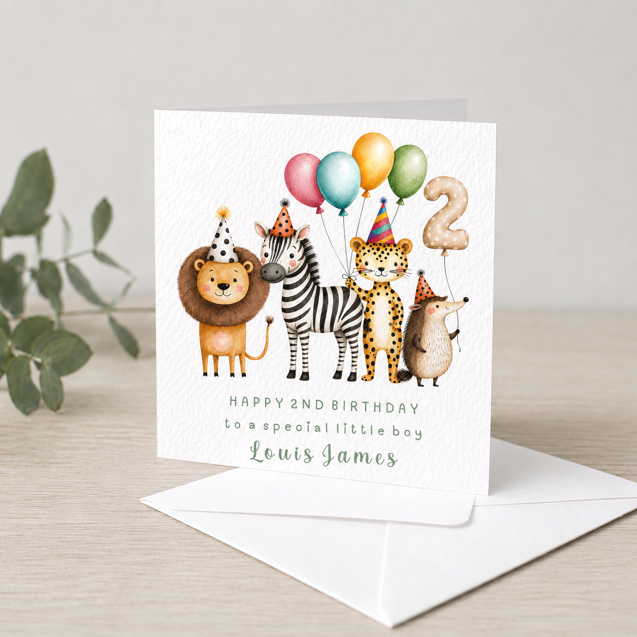 A birthday card with illustrated animals wearing party hats and holding balloons, celebrating a second birthday for a boy named Louis James.