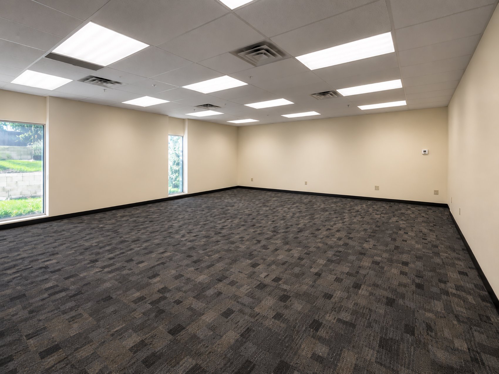 Large office room with two large windows.