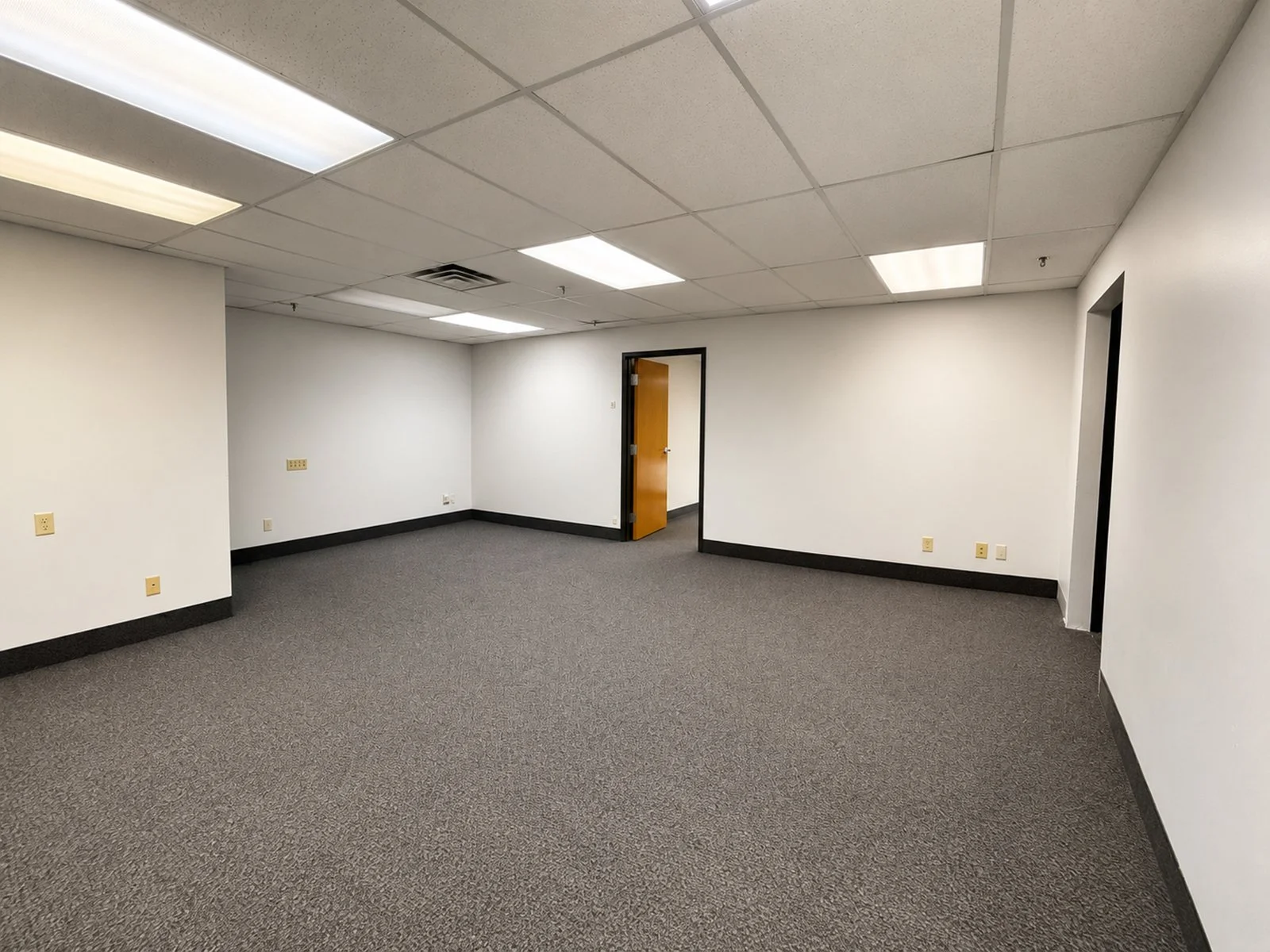 Large office room with white walls.