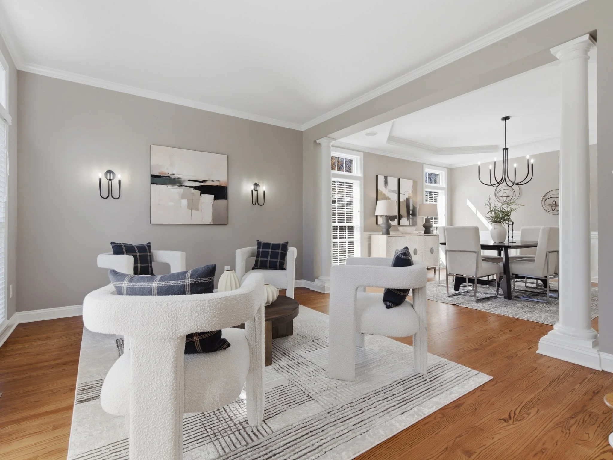 Staged sitting room with boucle chairs open to dining room