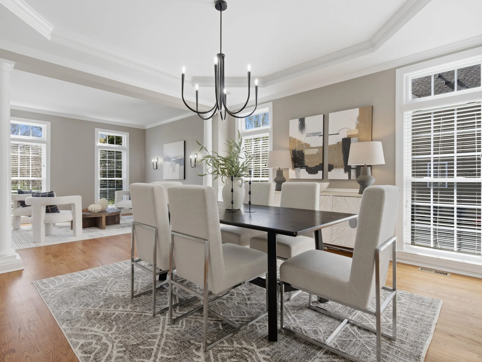 Staged dining room with black table and chrome dining chairs