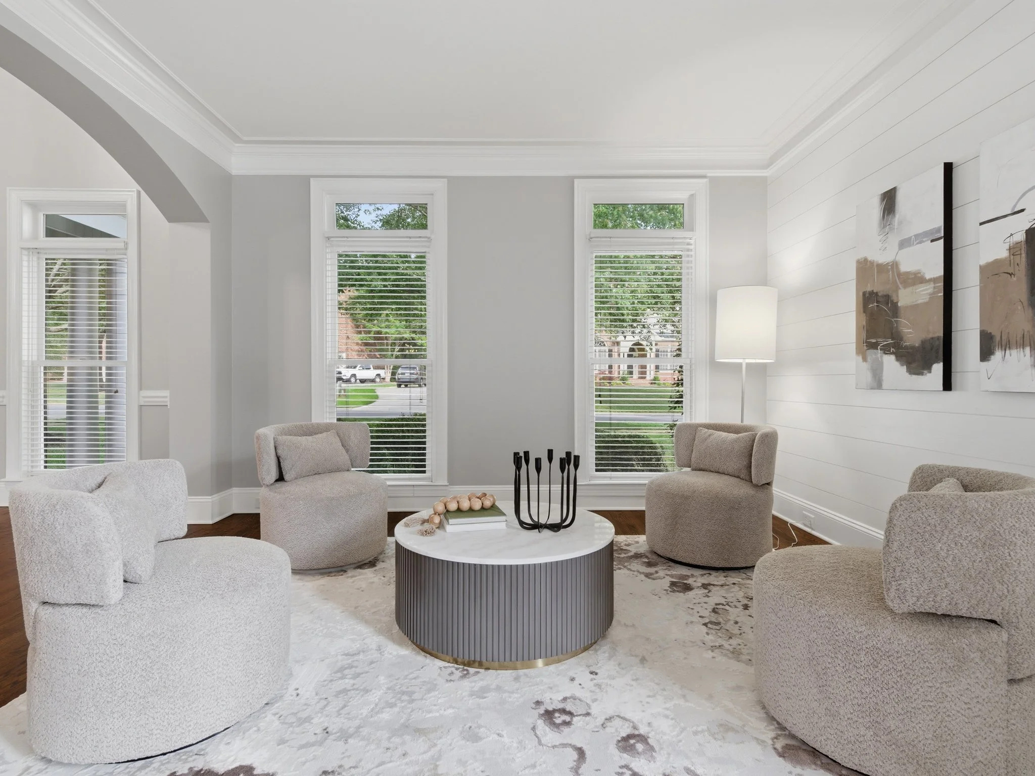 Staged sitting room with boucle chairs and fluted coffee table