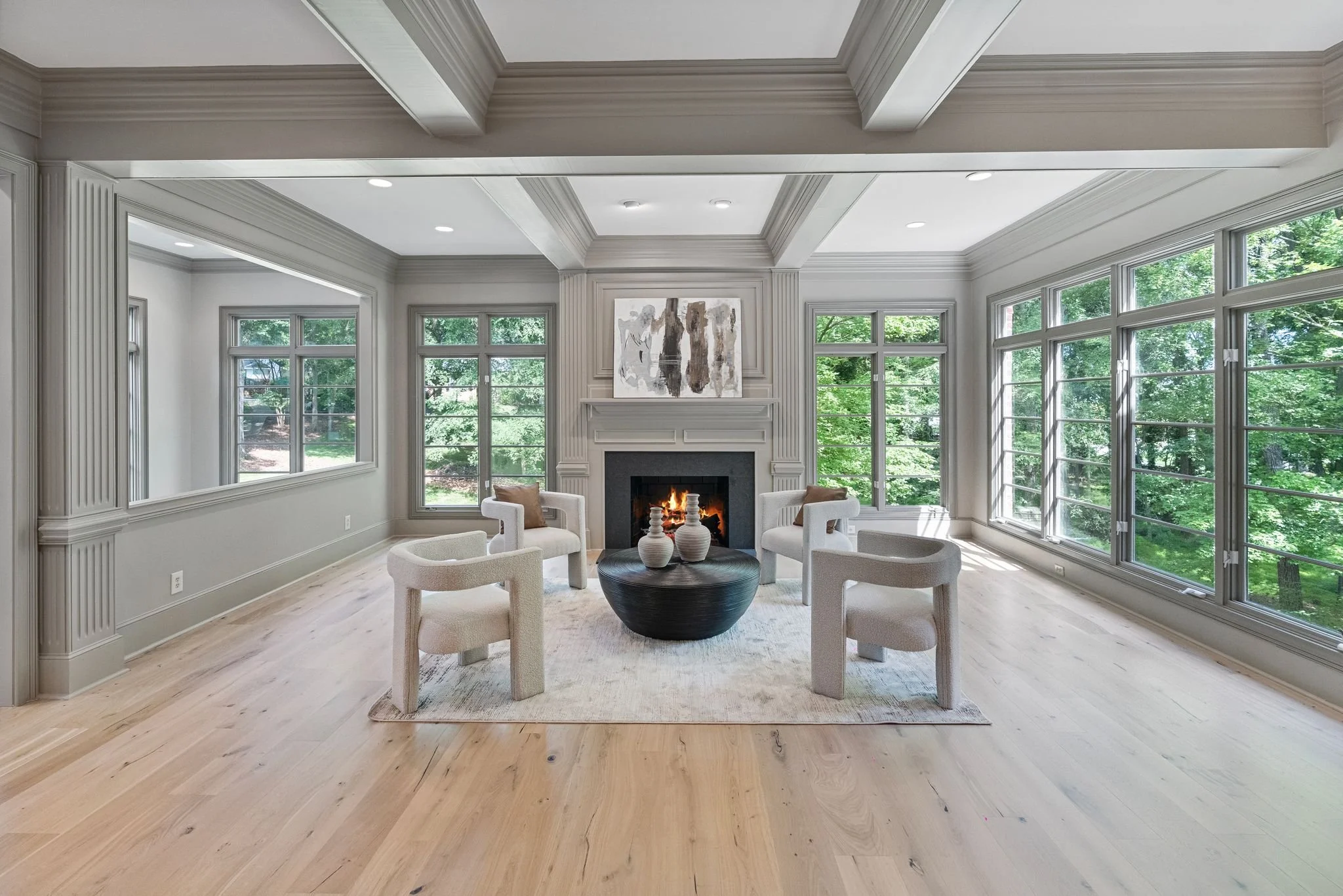Staged living room with black fireplace and round coffee table, Charlotte NC