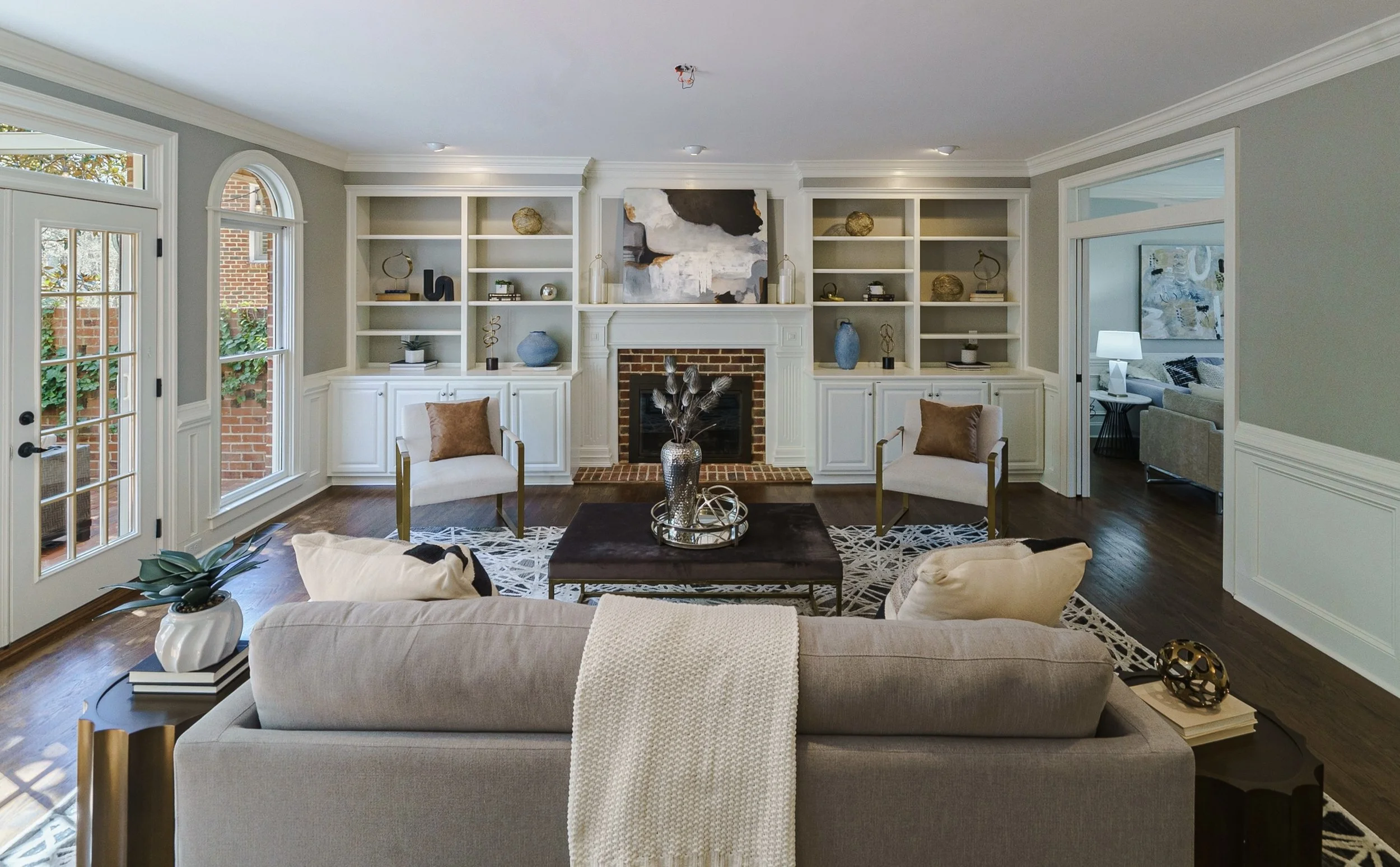 Staged living room with brick fireplace and built-in shelving