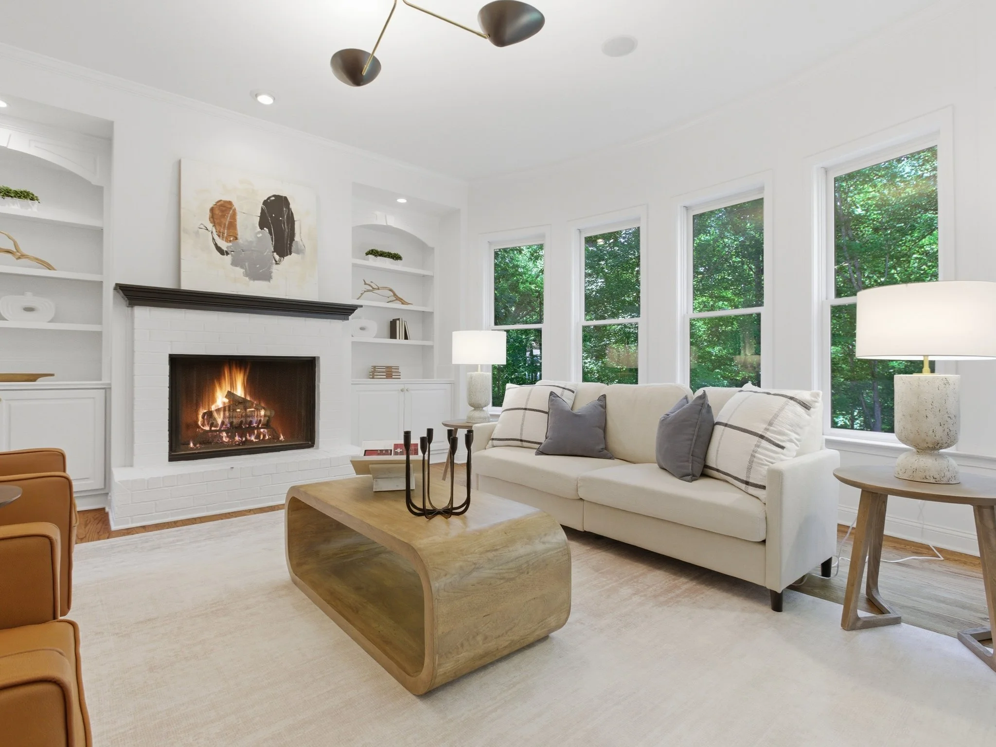 Staged living room with lit fireplace and built-in bookshelves, Charlotte NC