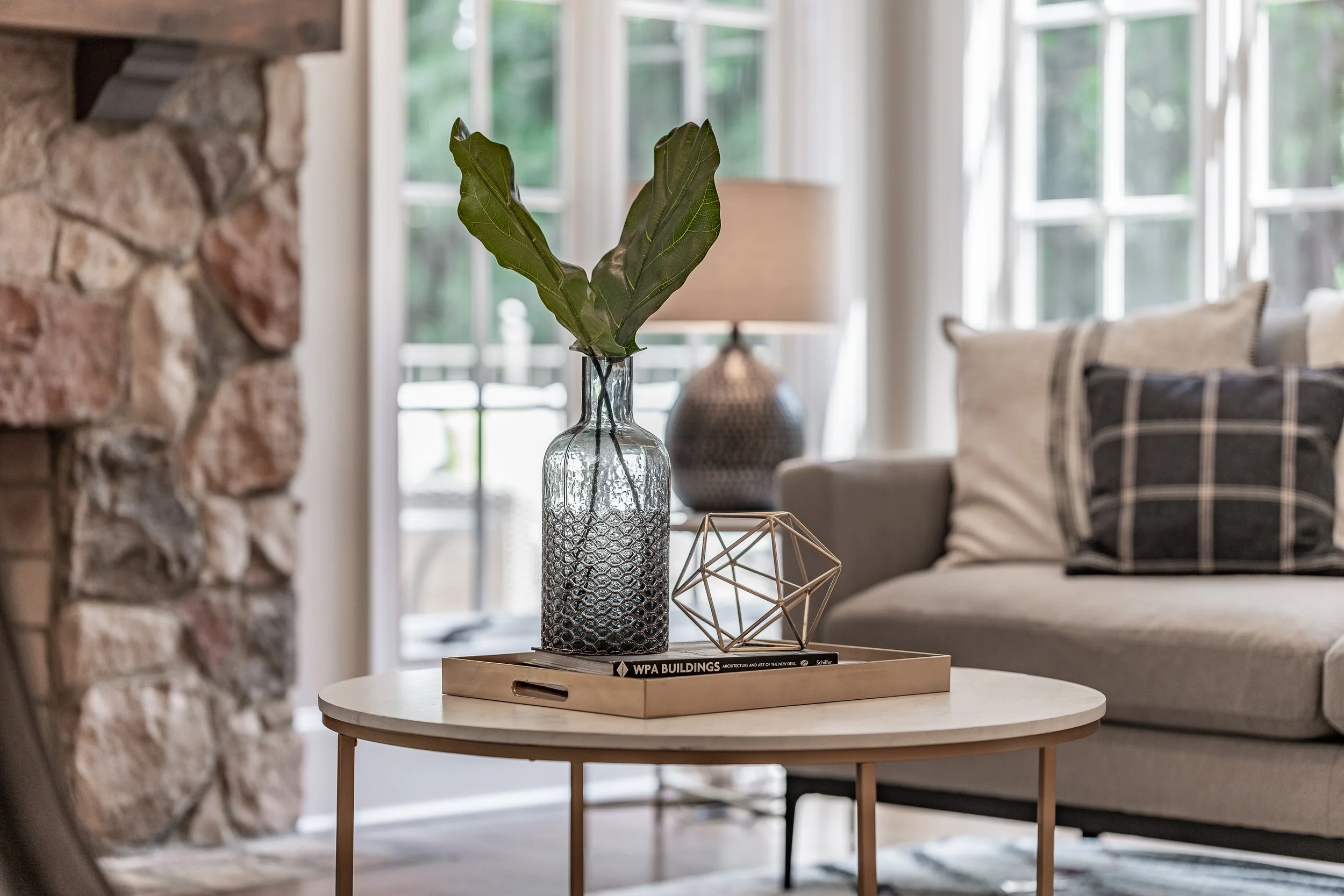 Staged coffee table vignette with fireplace in the background