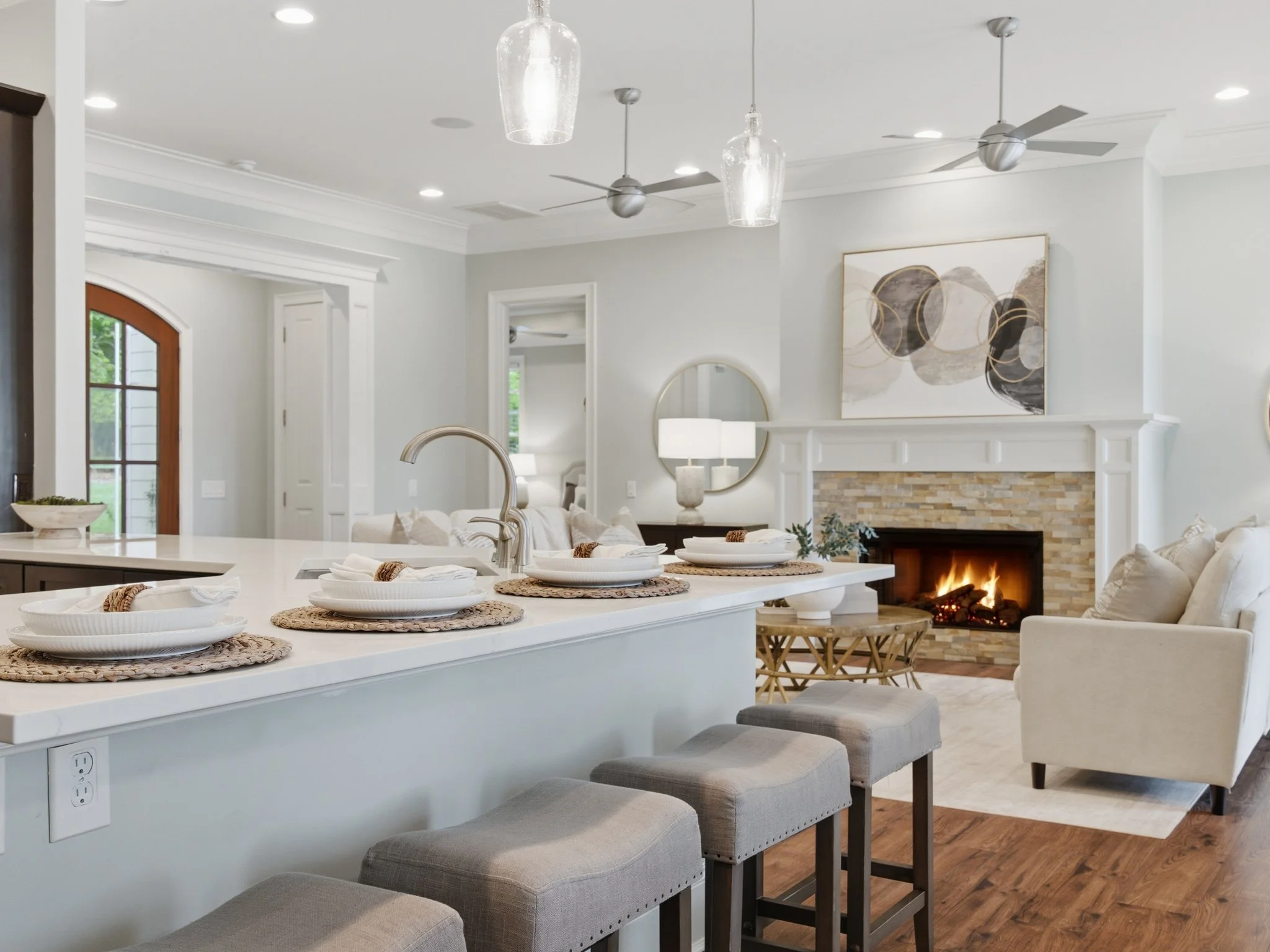 Staged kitchen island with view to living room fireplace