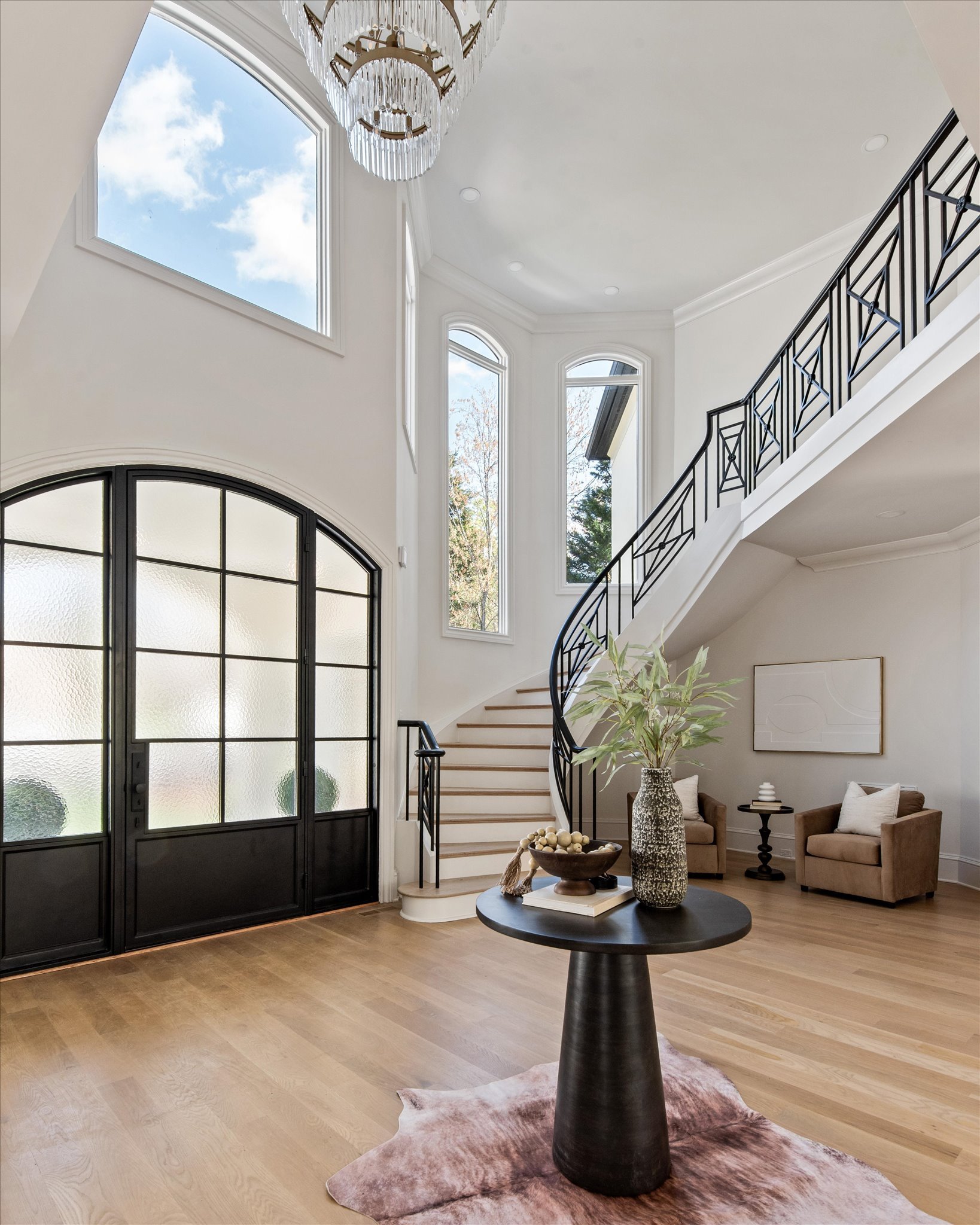 Staged grand foyer with crystal chandelier and arched windows, Mecklenburg County NC