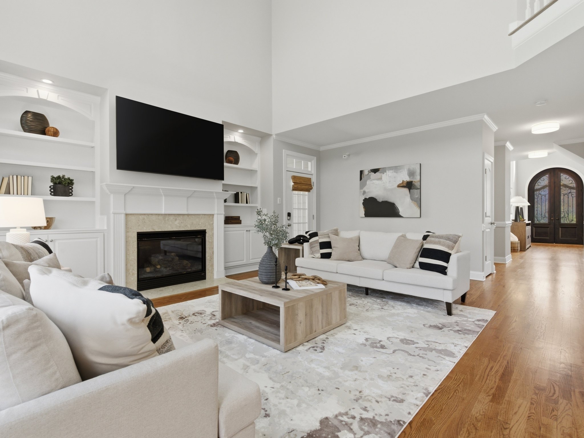 Staged living room with dual sofas and built-in shelving