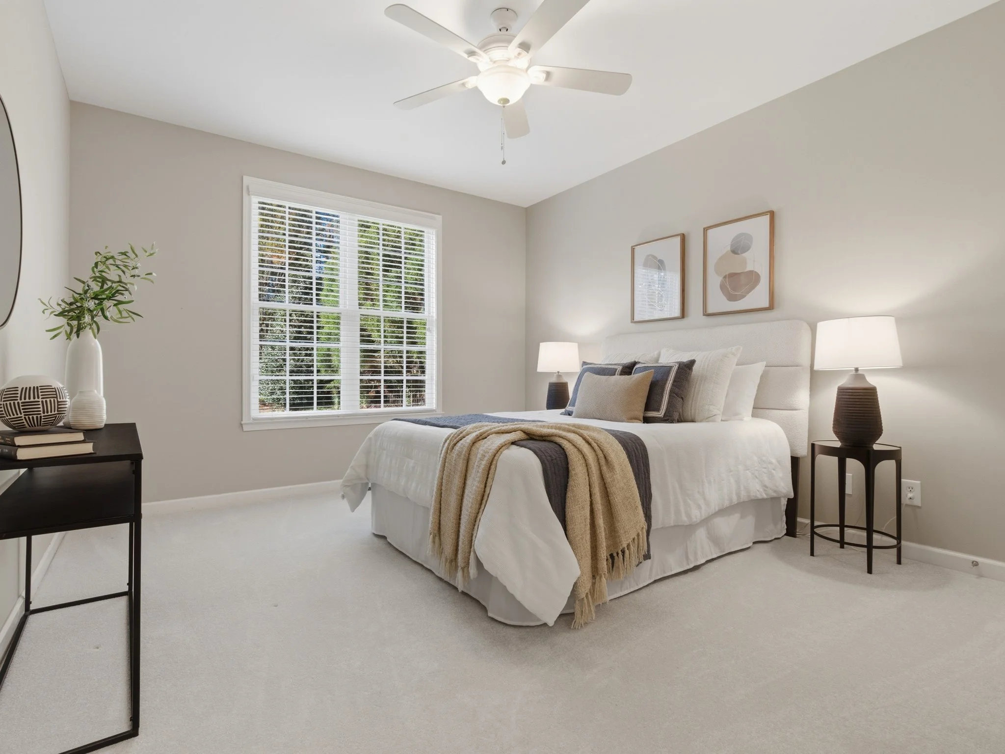 Staged bedroom with layered neutral bedding, Charlotte NC 