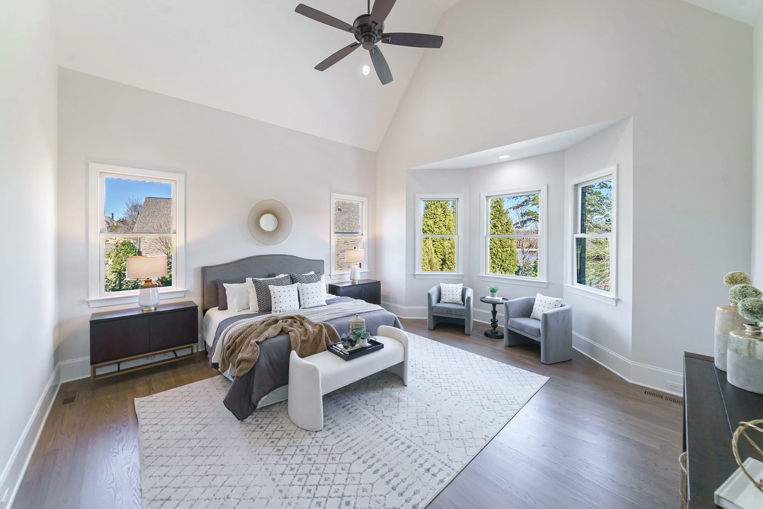 Staged primary bedroom with sitting area and bay window, Weddington NC