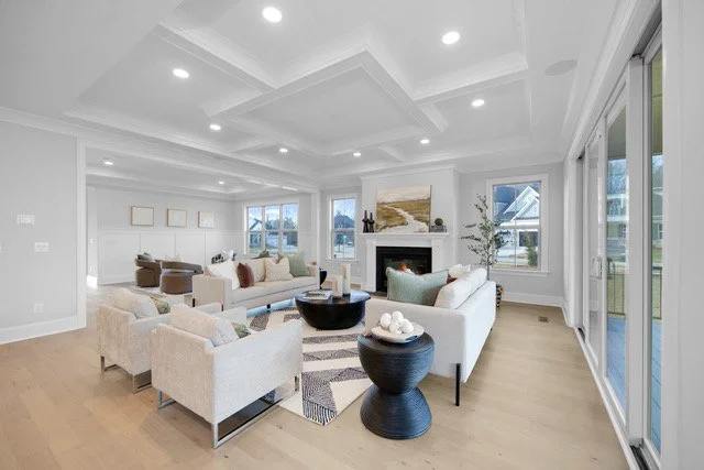 Staged living room with coffered ceiling and fireplace