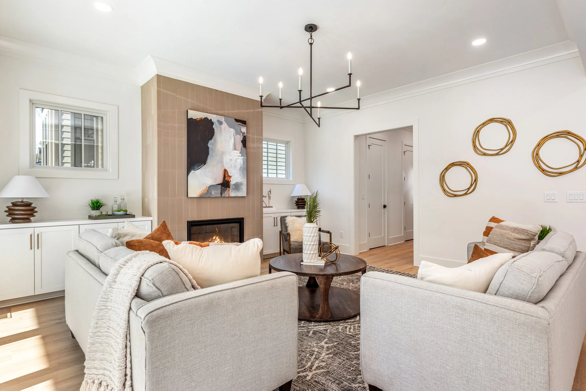 Staged living room with fluted fireplace surround
