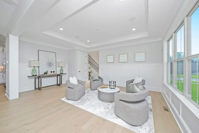 Staged sitting room with swivel chairs and console table