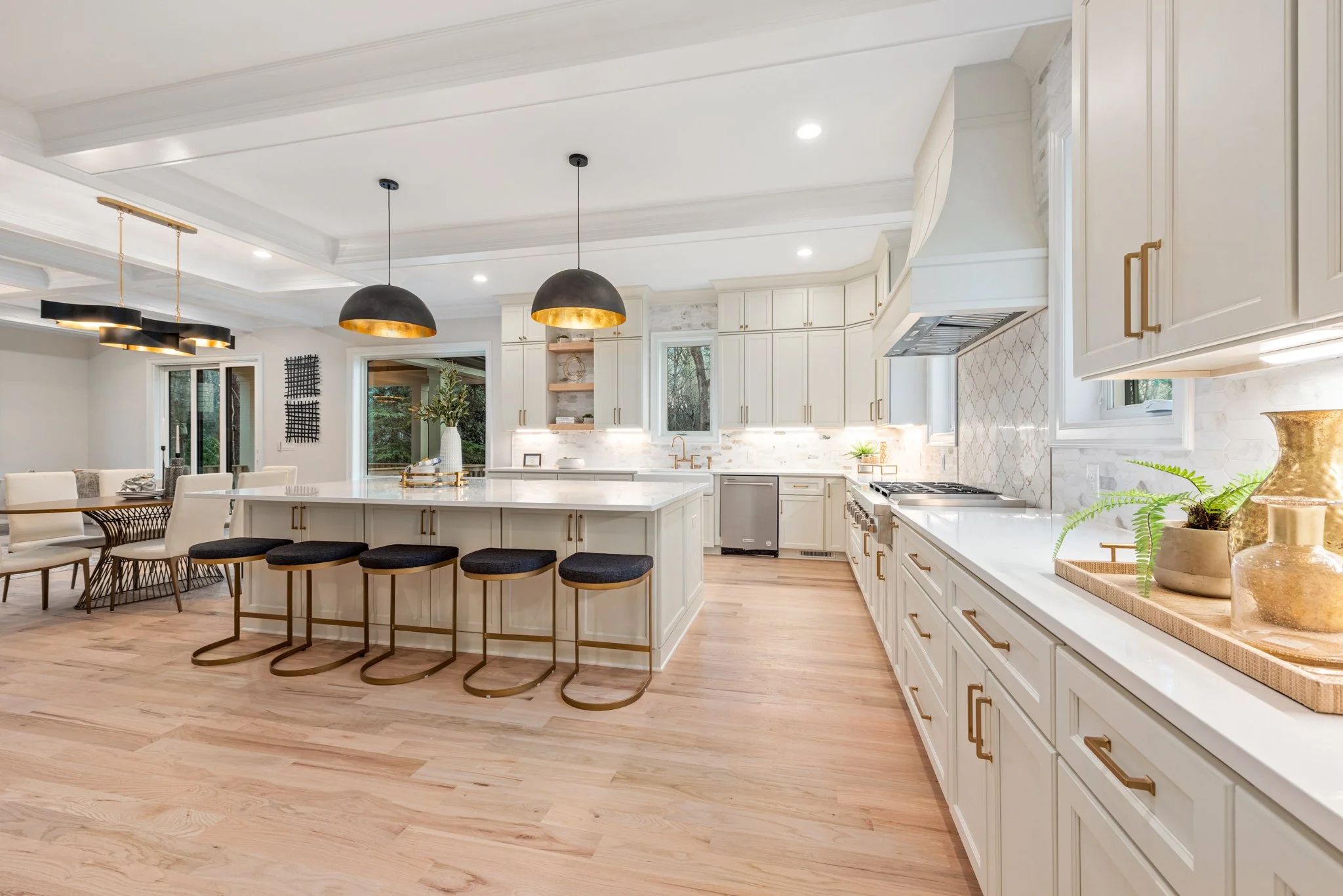 Staged kitchen with black dome pendant lighting and large island