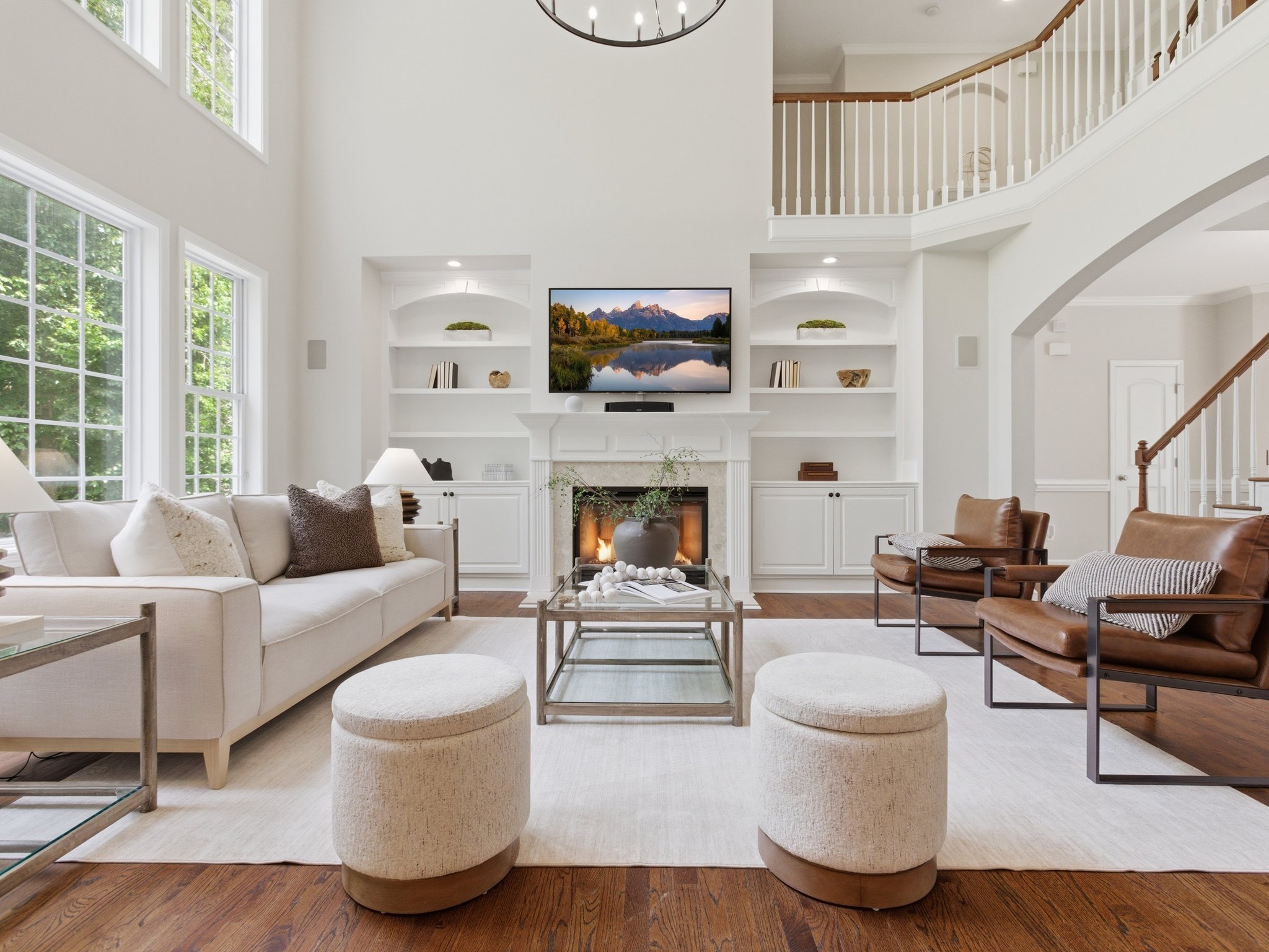 Staged living room with fireplace and leather accent chairs
