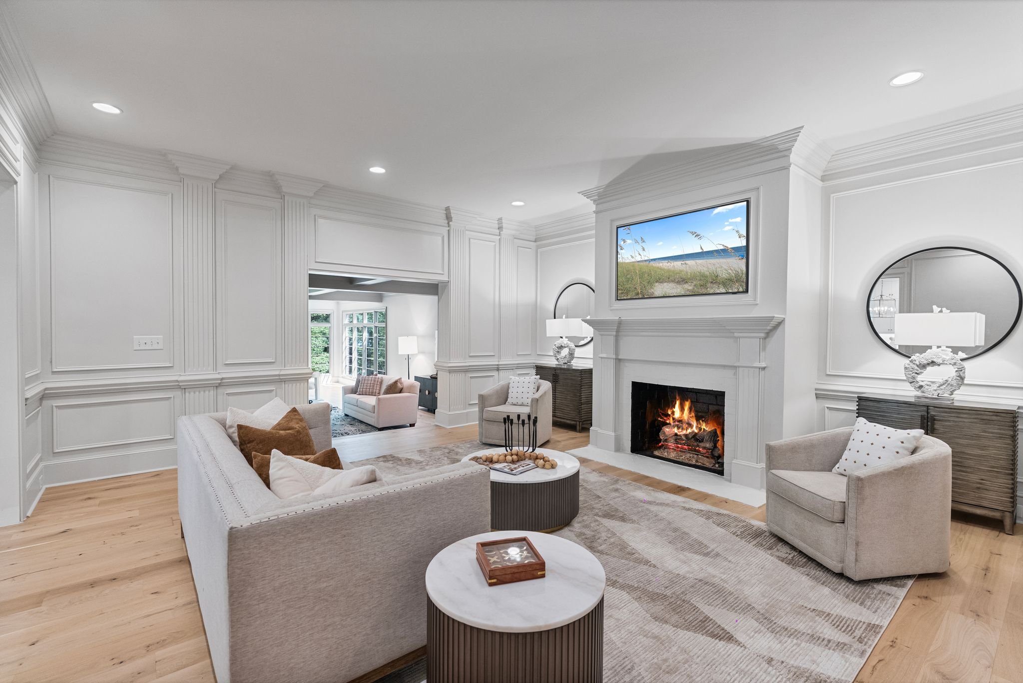 Staged living room with panel walls and gas fireplace
