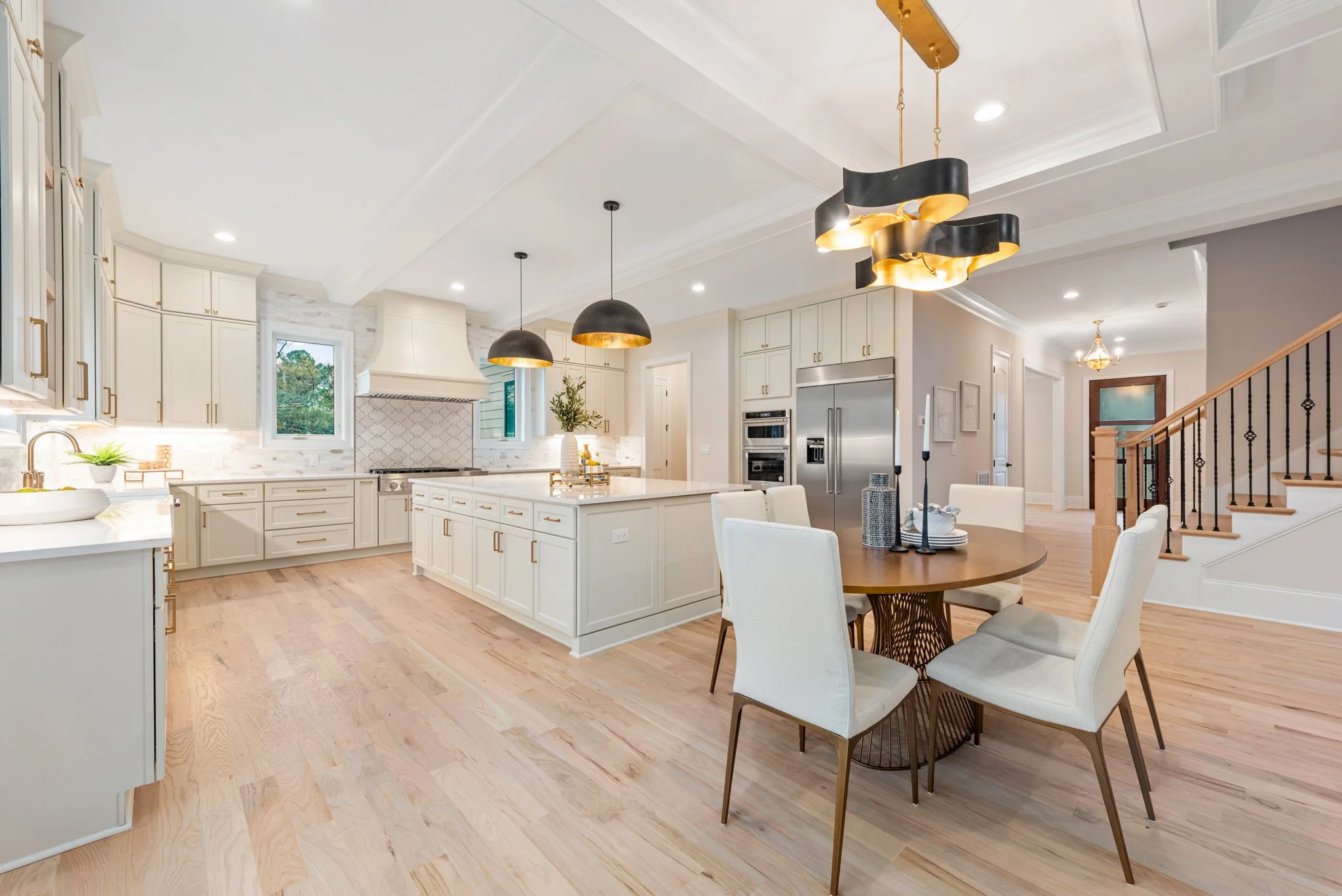 Staged kitchen and dining space with dome pendant lighting and marble backsplash, Charlotte NC