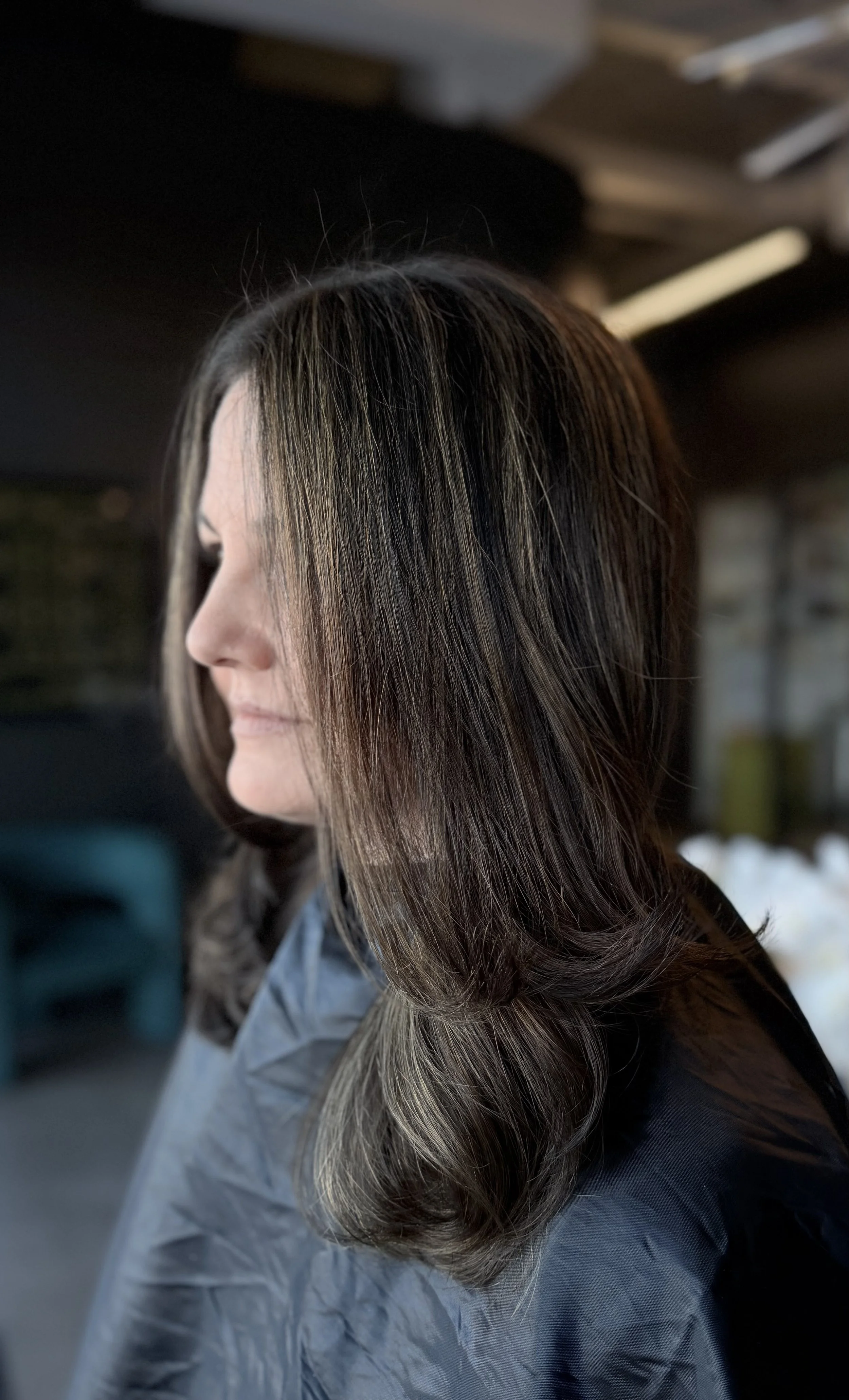 Long layered haircut with soft movement and shine.