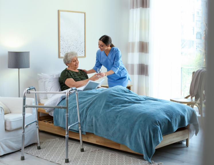Ezer HHA Agency home health aide assisting an elderly client with safe mobility and daily activities.