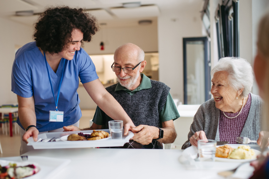 Caregiver preparing a healthy meal for a senior receiving in-home care from Ezer HHA Agency.