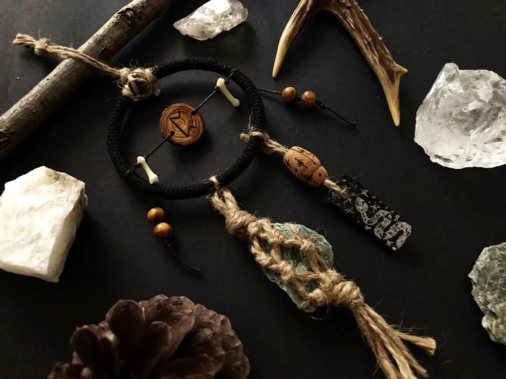 “Runic Artefact"  
Pyrography on wood, naturally gathered fox bones, serpentinite stone, acrylic paint on wood, rope, wood, and metal.