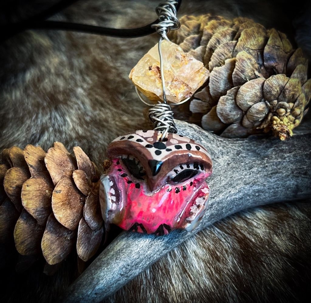 "Shamanic Little Owl" - Guardian Talisman  
Carved avocado seed, acrylic paint, metal wire, raw quartz gathered in nature.