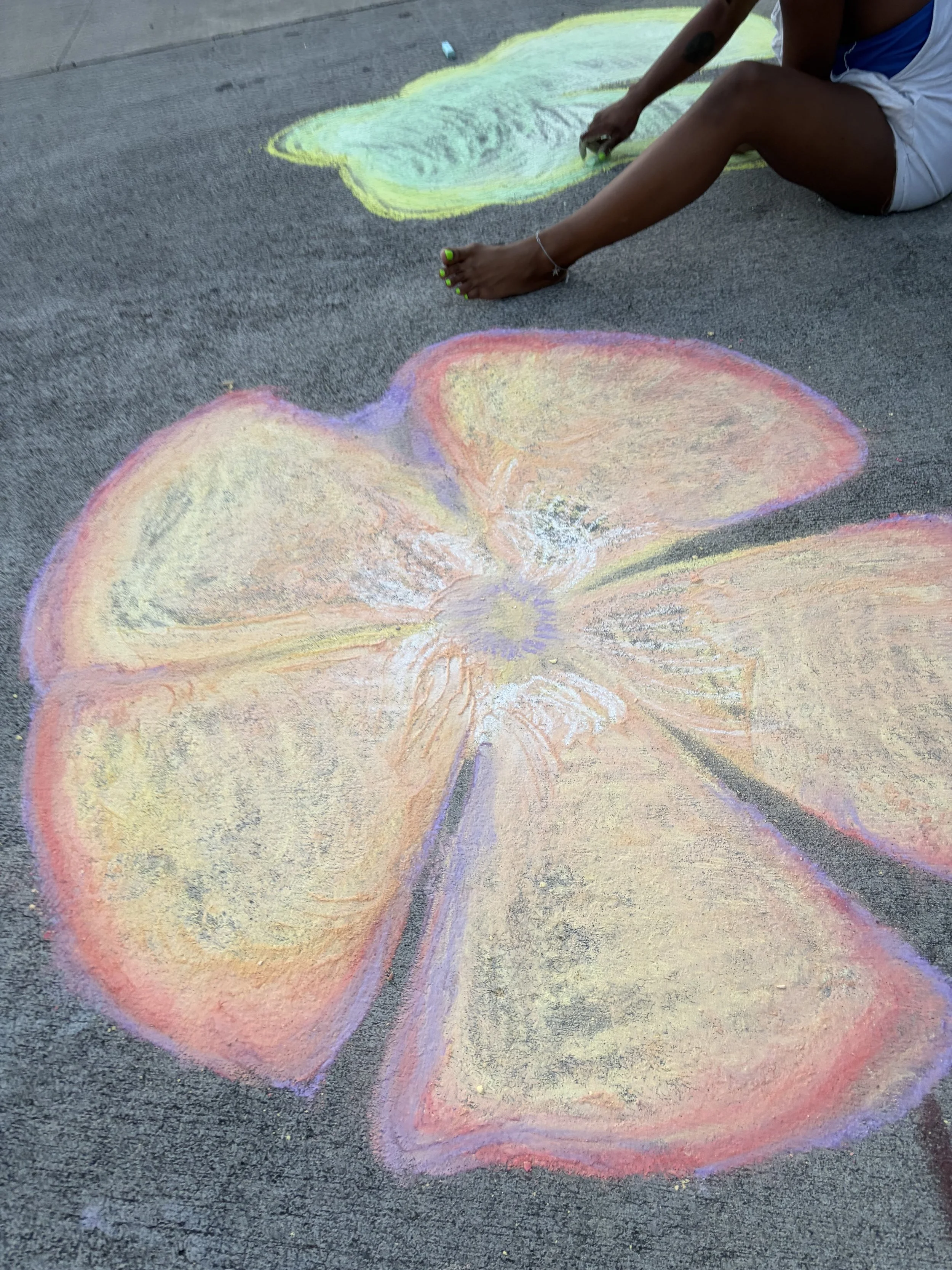 Colorful chalk drawing of a butterfly on the pavement.