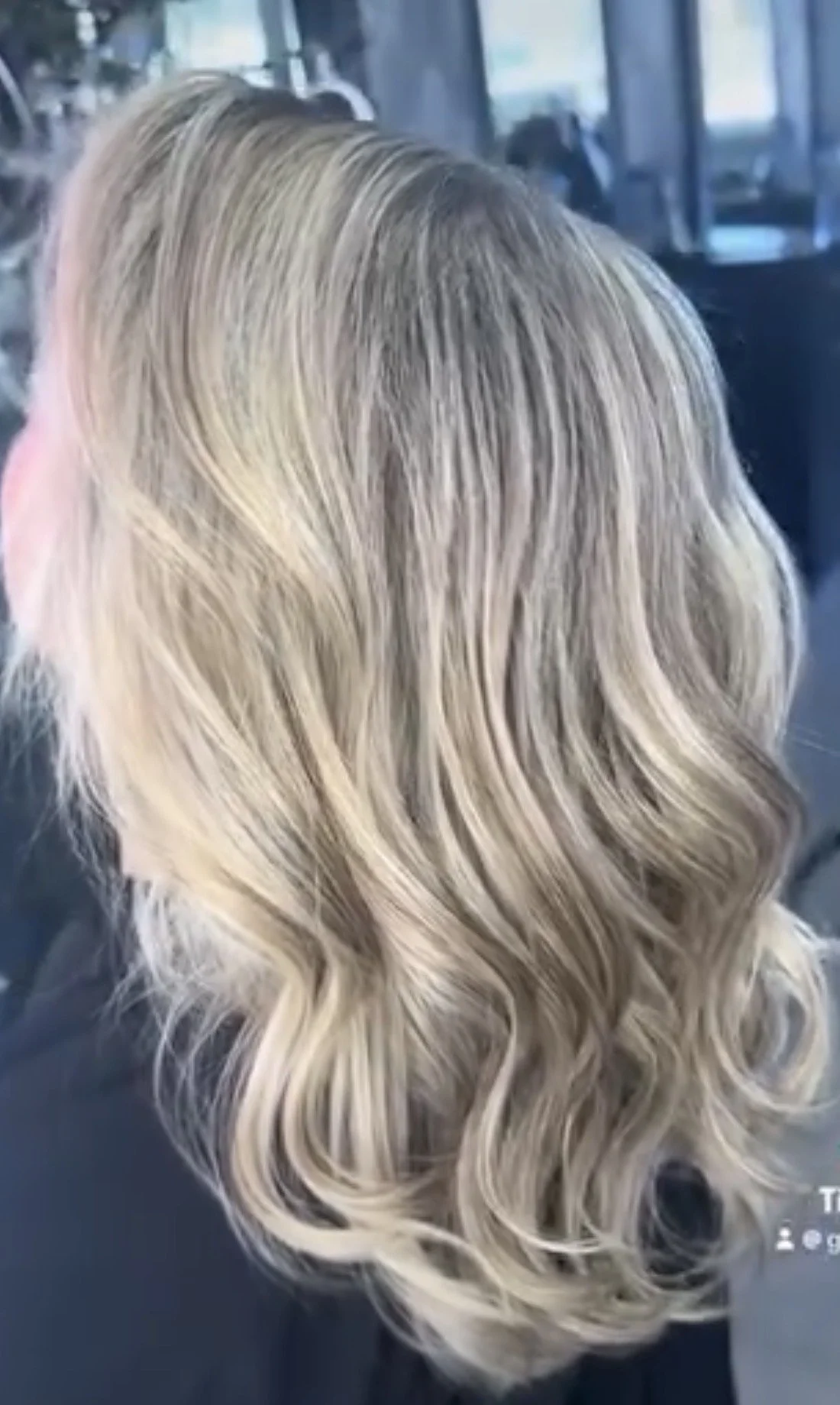 Blonde hair styled in loose waves.