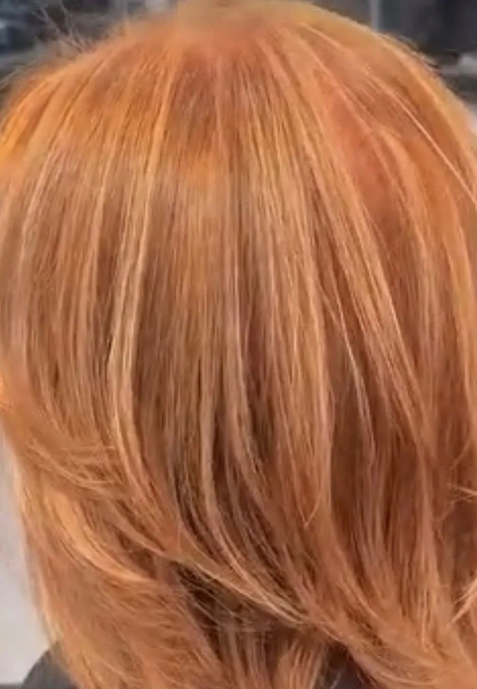 Close-up of straight, shoulder-length, copper-colored hair.