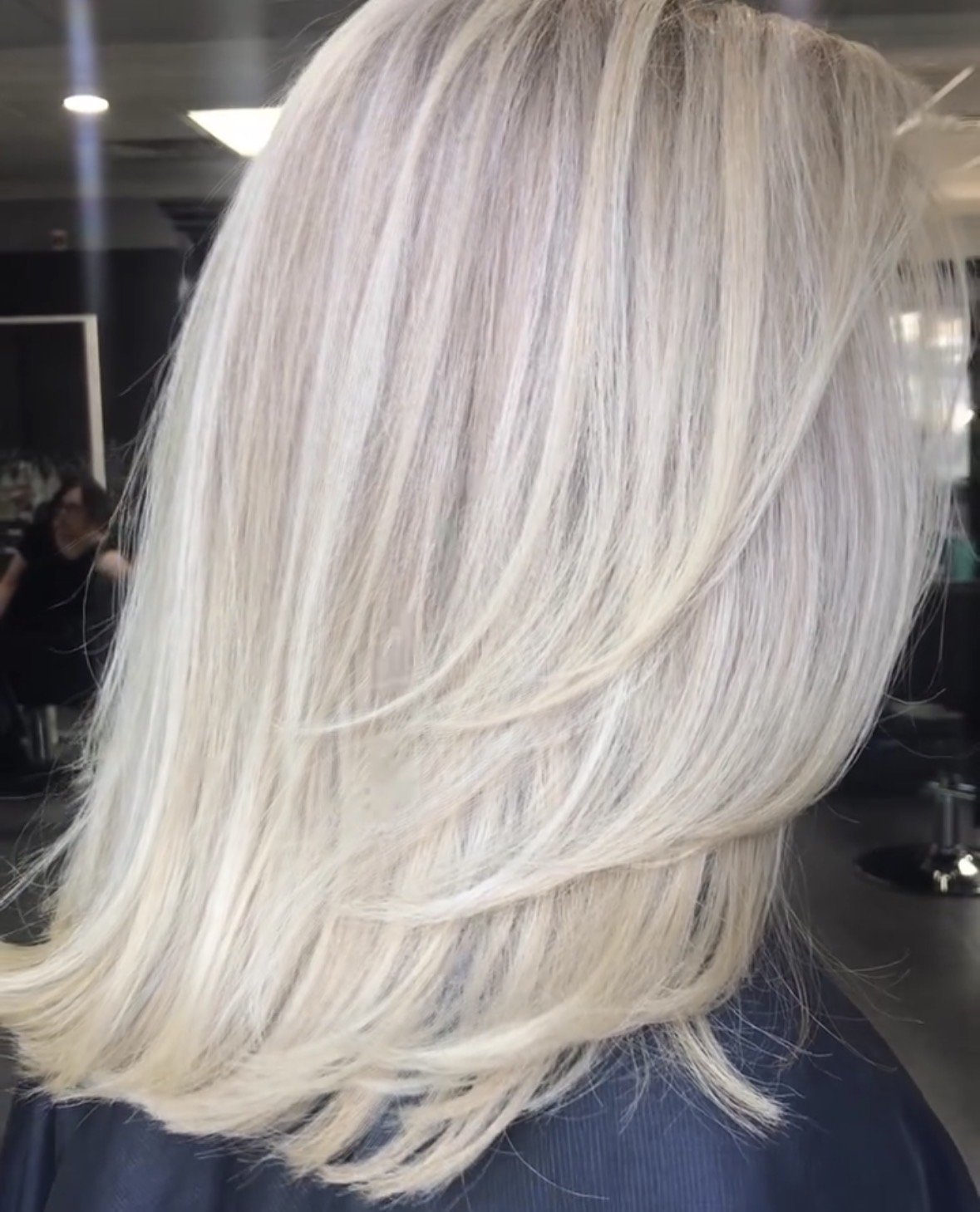 Back of a person with long, platinum blonde hair.