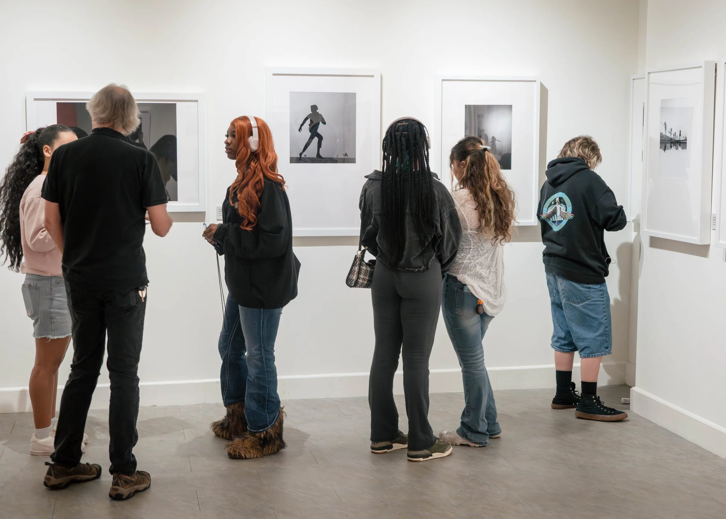 Exhibition visitors experiencing Dimpy Bhalotia’s mobile photography exhibition at the Florida Museum of Photographic Arts.