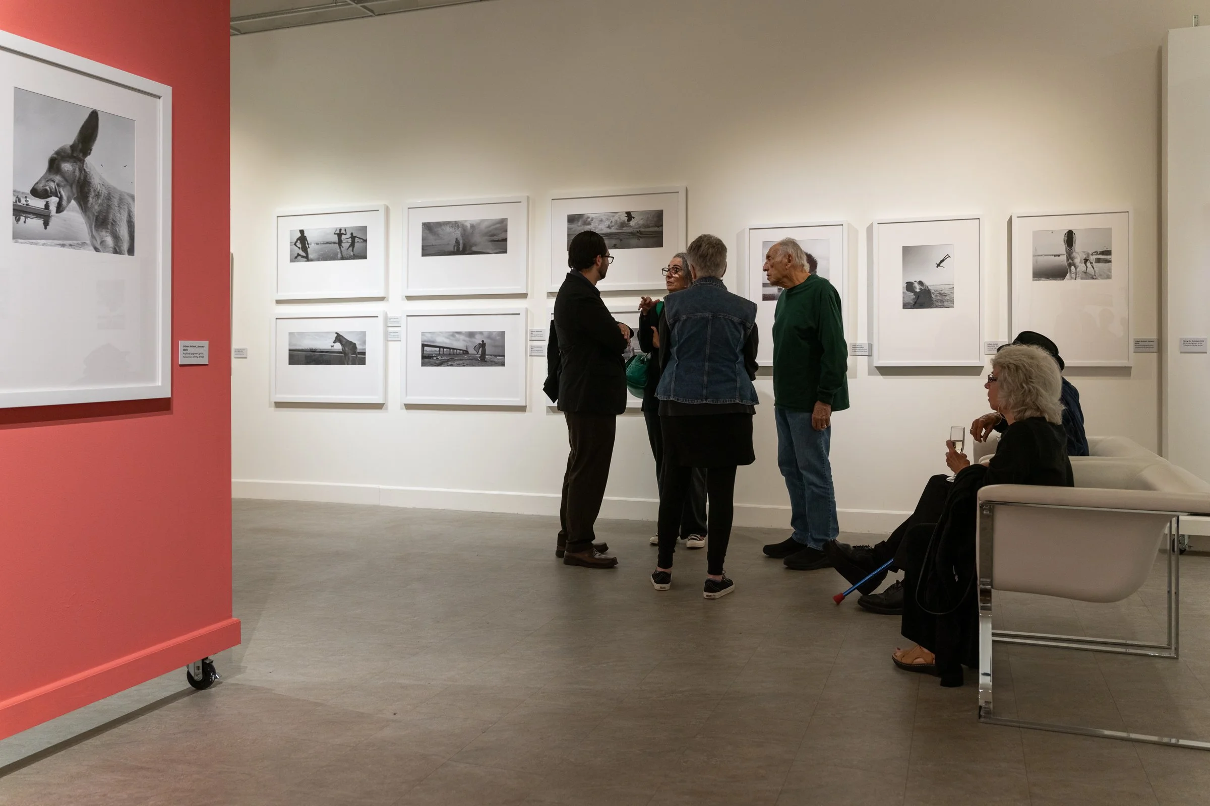 Museum gallery displaying black and white street photographs by Dimpy Bhalotia during her solo exhibition.