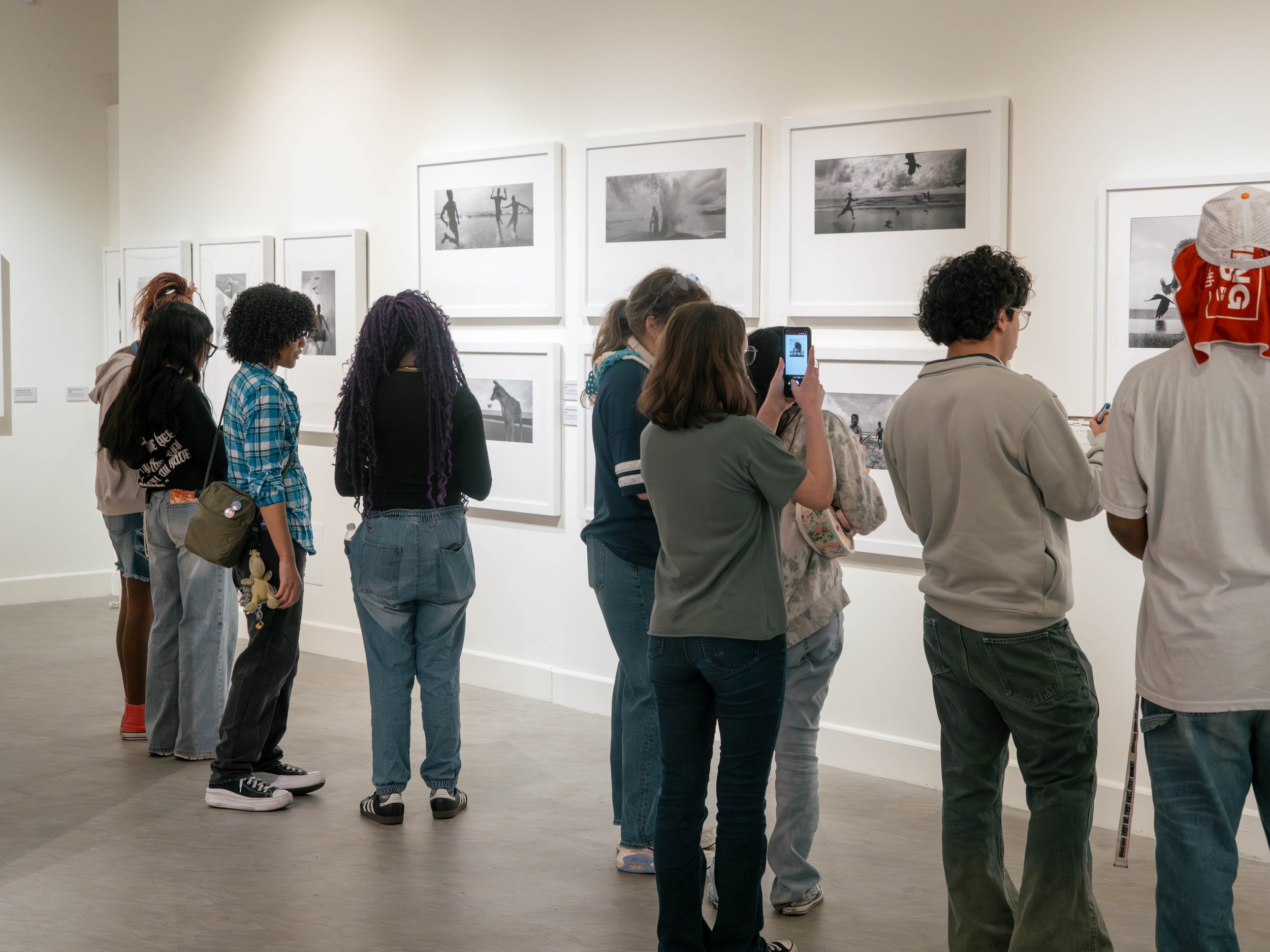 Gallery installation featuring photographs from Dimpy Bhalotia’s solo street photography exhibition at the Florida Museum of Photographic Arts.