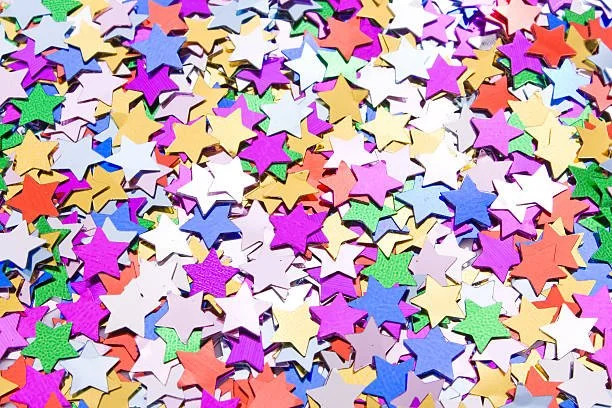 Colorful star-shaped confetti scattered across a surface.