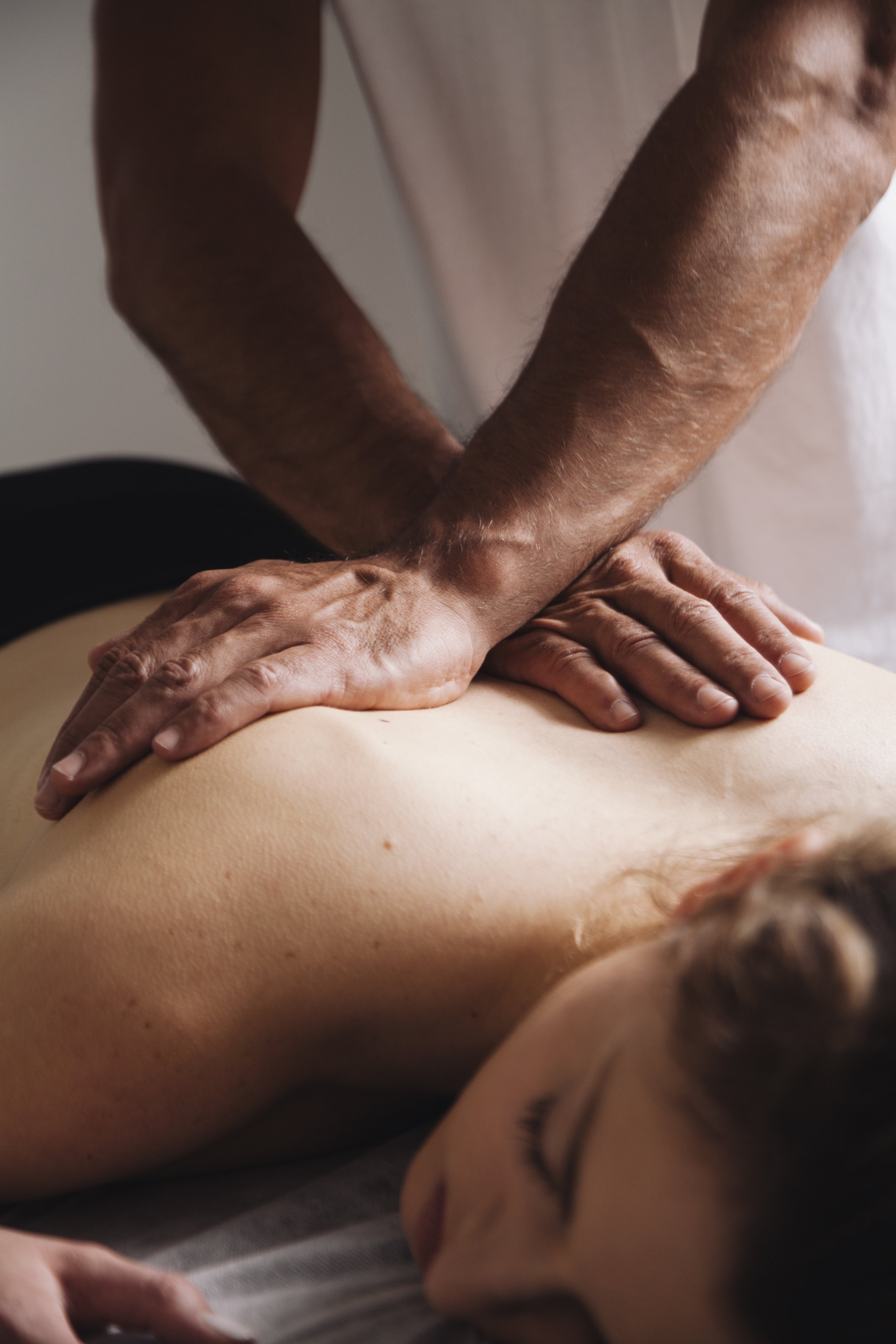 Therapist performing myofascial release massage on a client's back