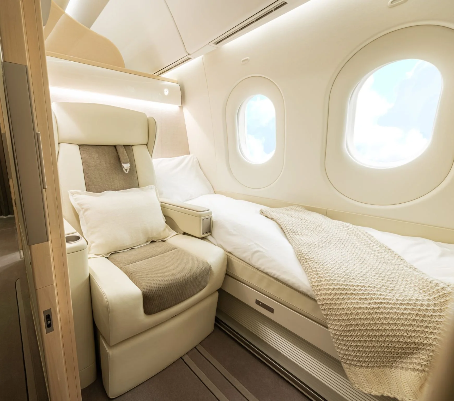 Private aircraft suite with convertible seating, bedding, and panoramic windows