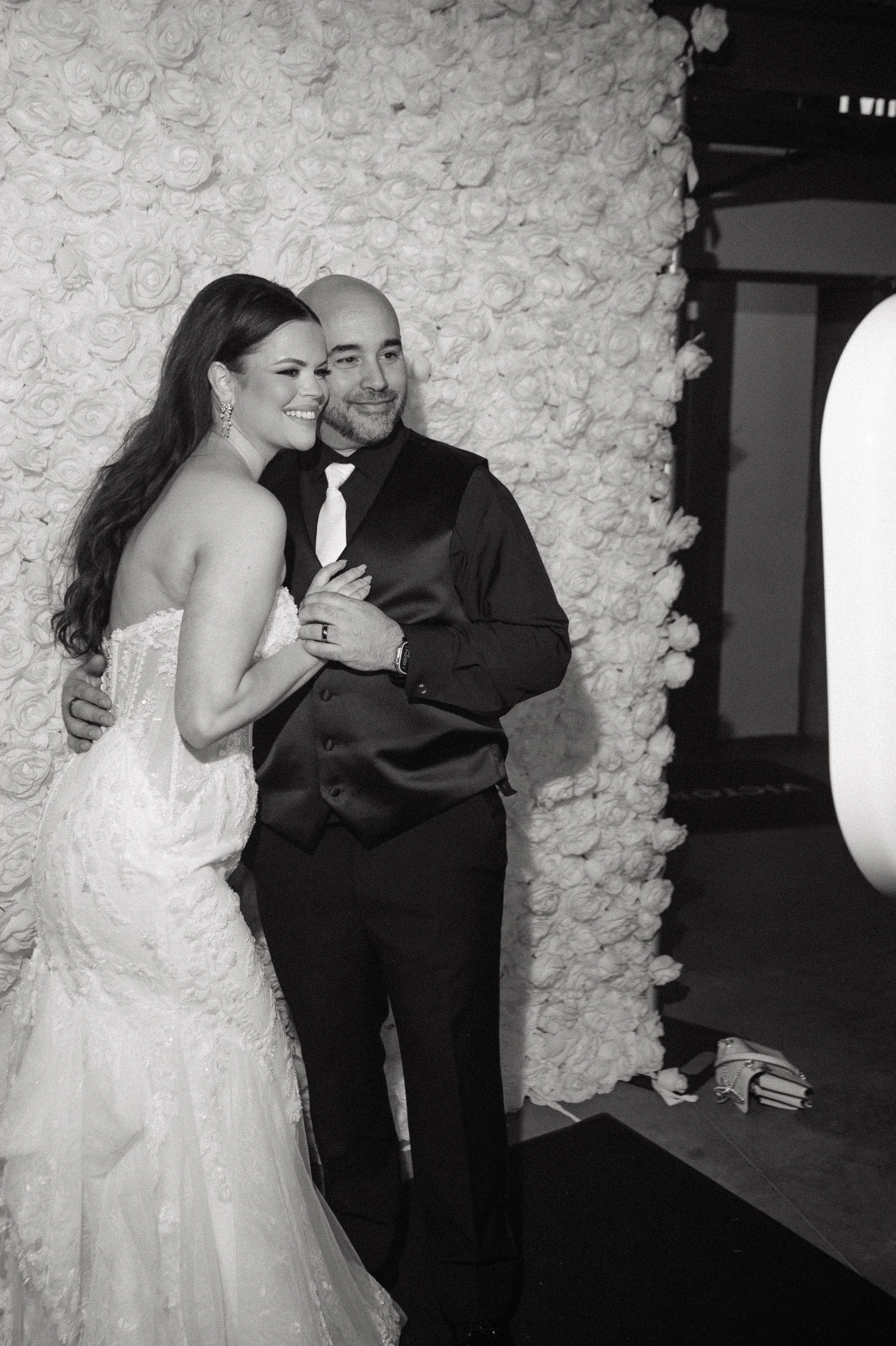 Bride and groom posing in front of a luxury photo booth backdrop at a Savannah wedding