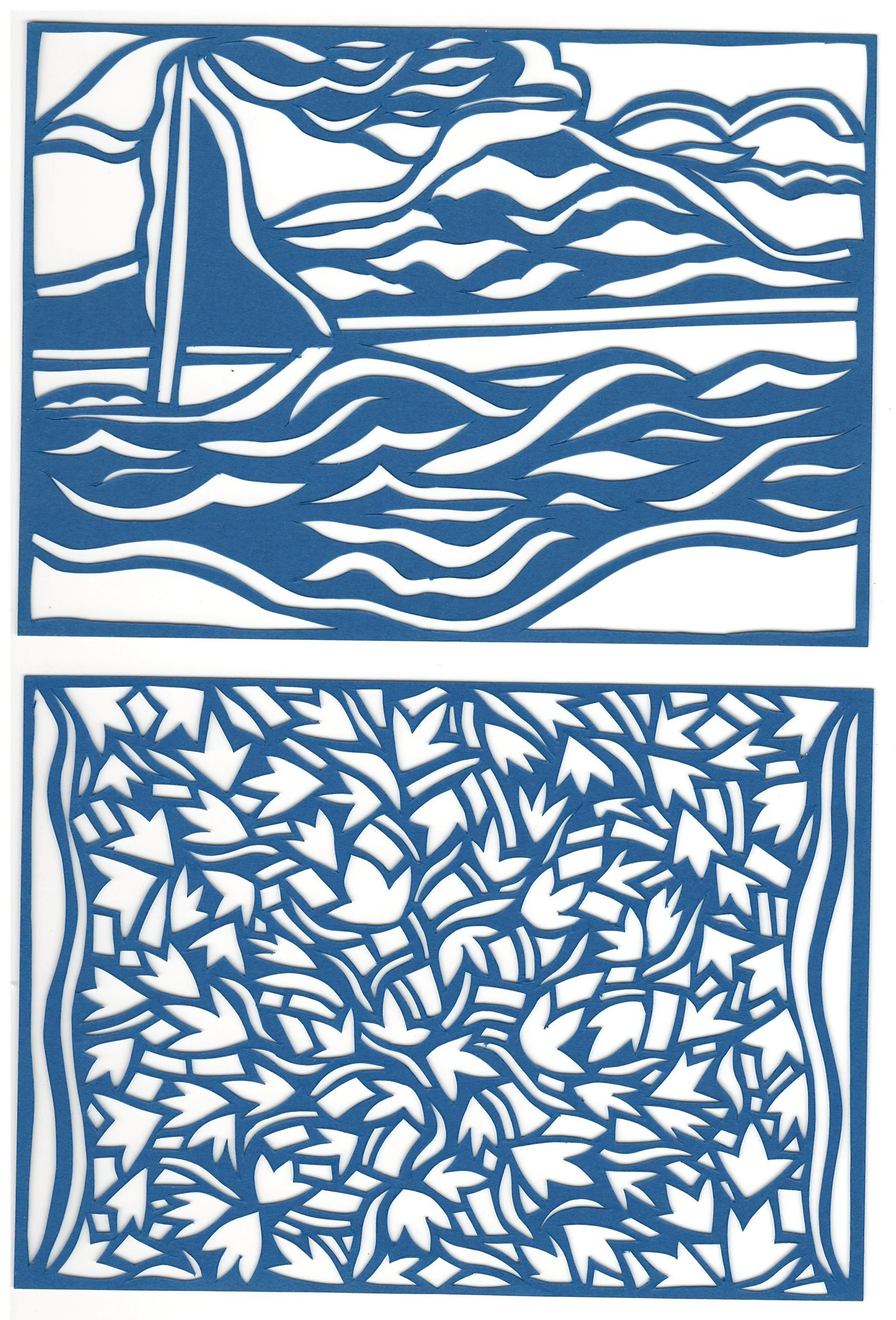 Blue paper cutout with a beach scene including a sailboat, ocean waves, mountains, and a sky with clouds.