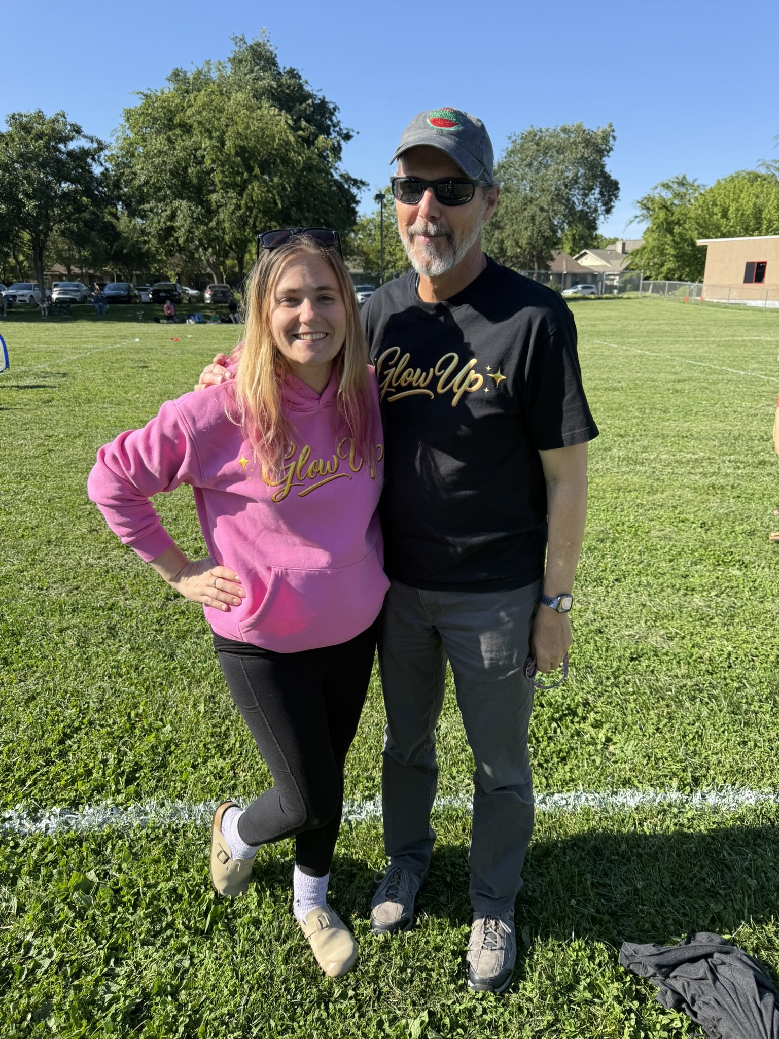 Jessica and her dad Steven wearing their Glow Up Merch
