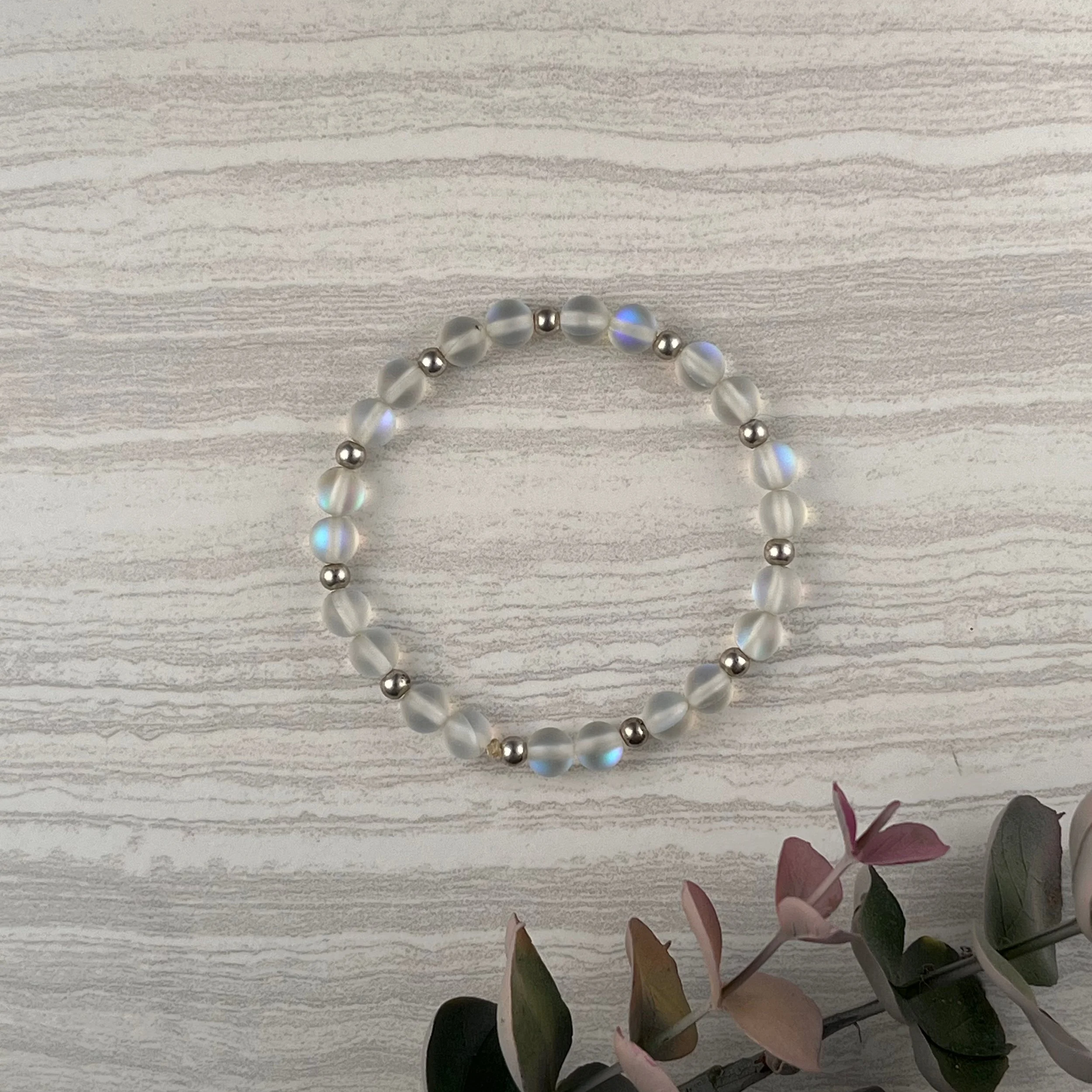 Frosted Mist: Soft frosted glass beads with a subtle iridescent shimmer are accented with polished silver spacers, creating a bracelet that's simple and catches the light with every movement. $20