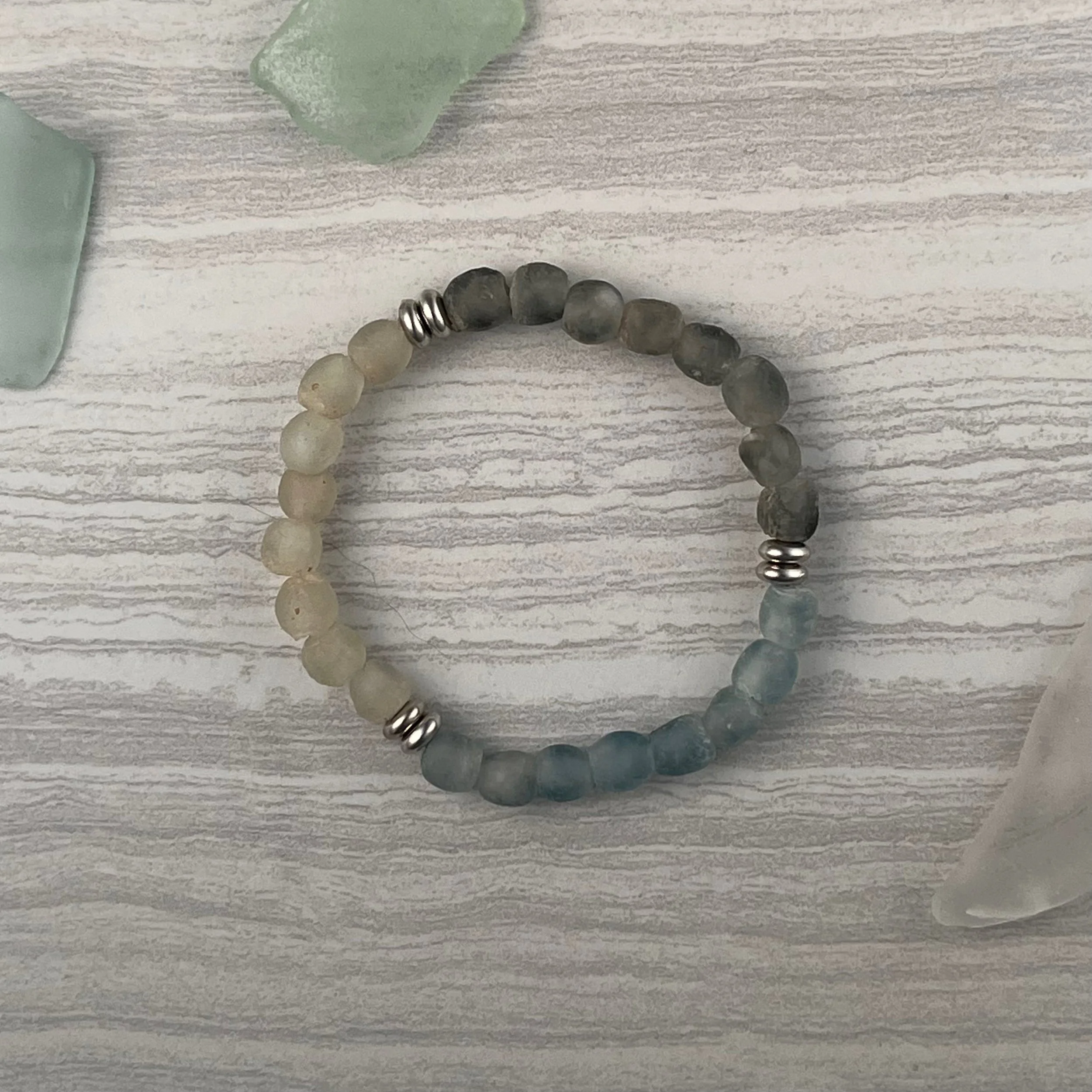 Sea Glass: A coastal inspired mix of gray, clear and blue recycled glass beads finished with silver accents. 
$20