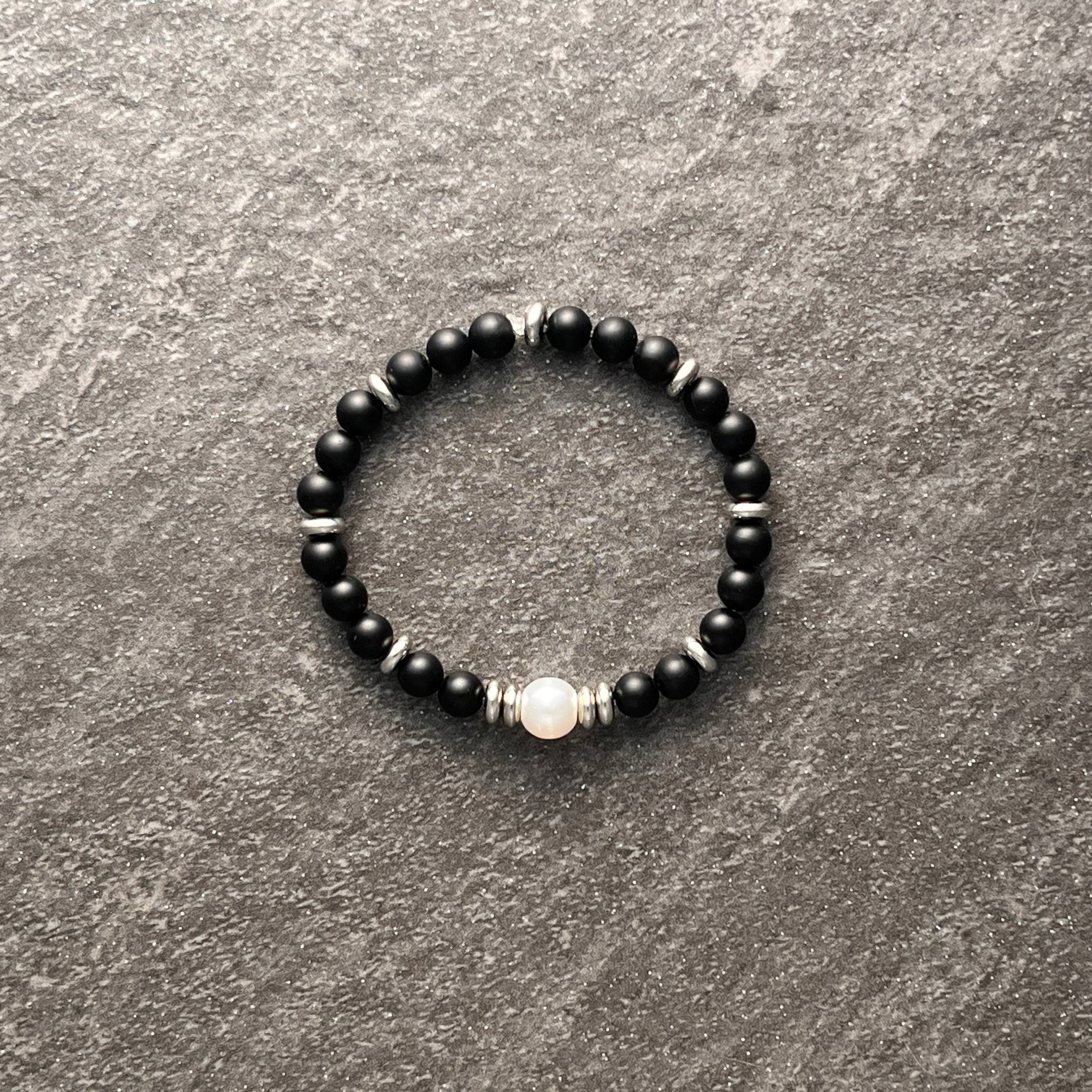 Statement Pearl: Matte black glass beads are paired with a glowing pearl focal bead and finished with silver spacer beads for a clean sophisticated look. 
$20 