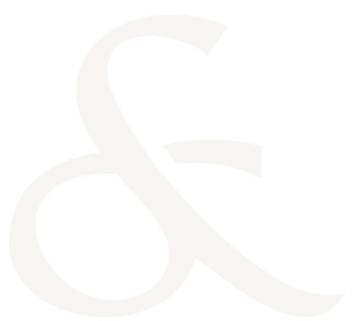 Close-up of a large white ampersand symbol on a black background.