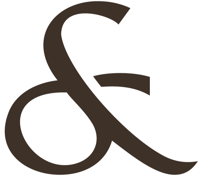 Close-up of a large, stylized dark brown ampersand symbol.