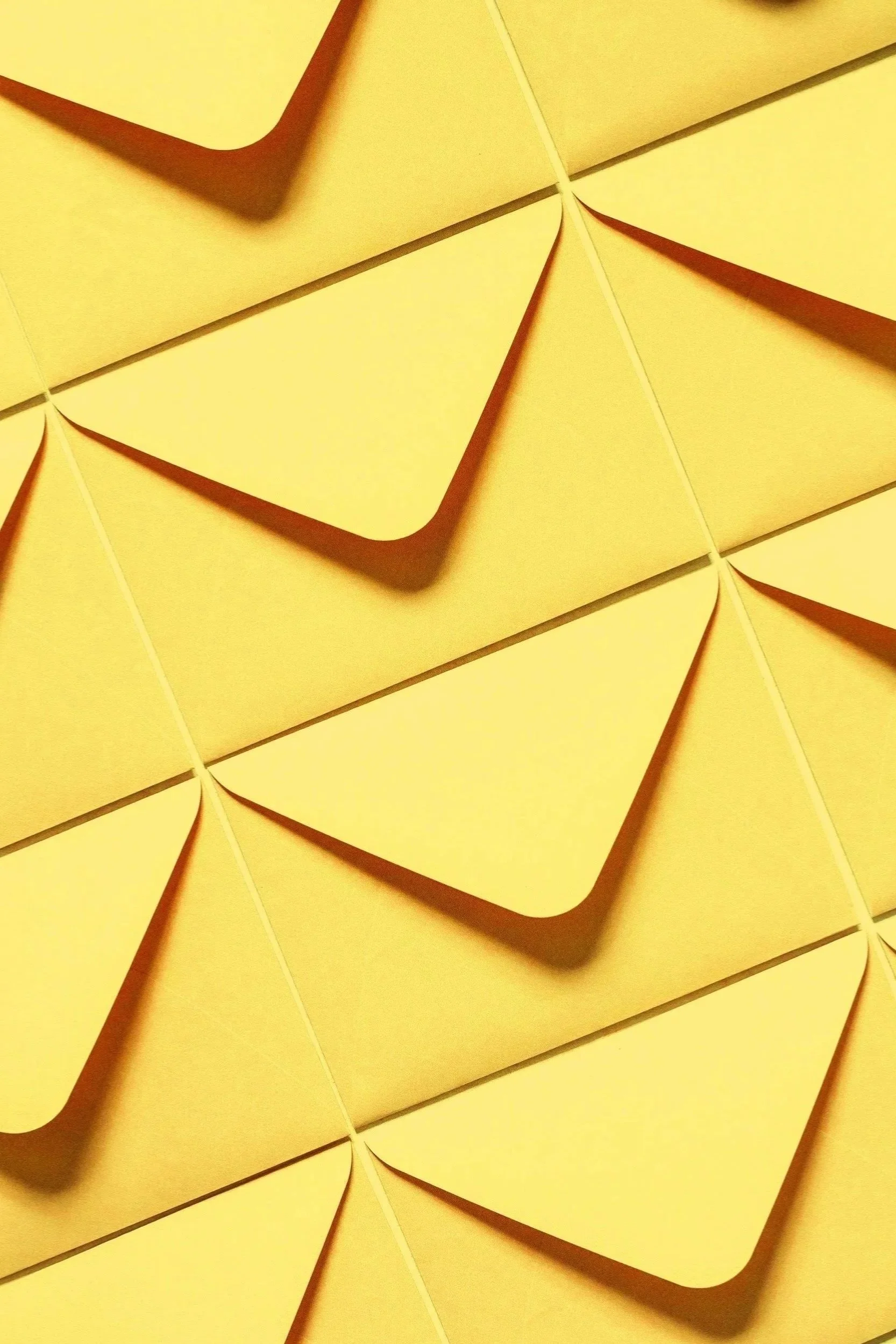 Close-up of yellow sticky notes with curled edges, arranged in a pattern.
