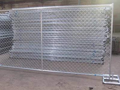 Large metal gate with chain link fencing and support pipes at the bottom.