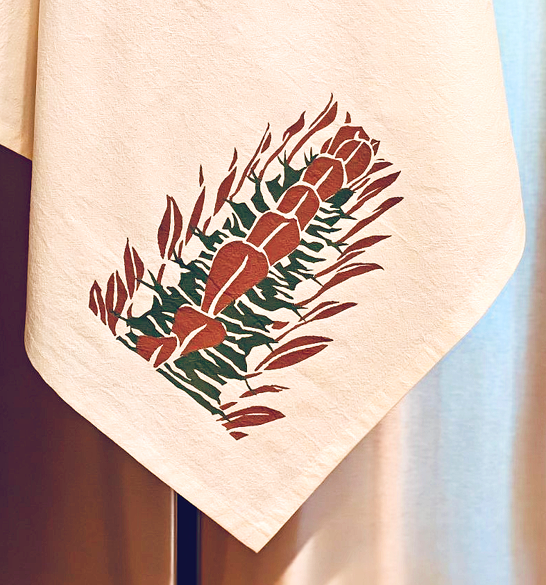 Image of cotton tea towel with original Euphobia trigona 'Rubra' screen printed design from Handforth Botanical Studio