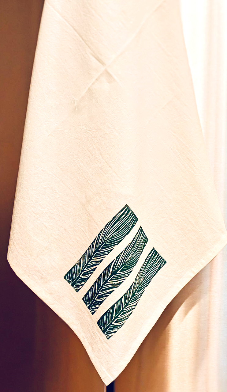 Image of cotton tea towel with original Canna 'Tropicana' leaf linocut design from Handforth Botanical Studio